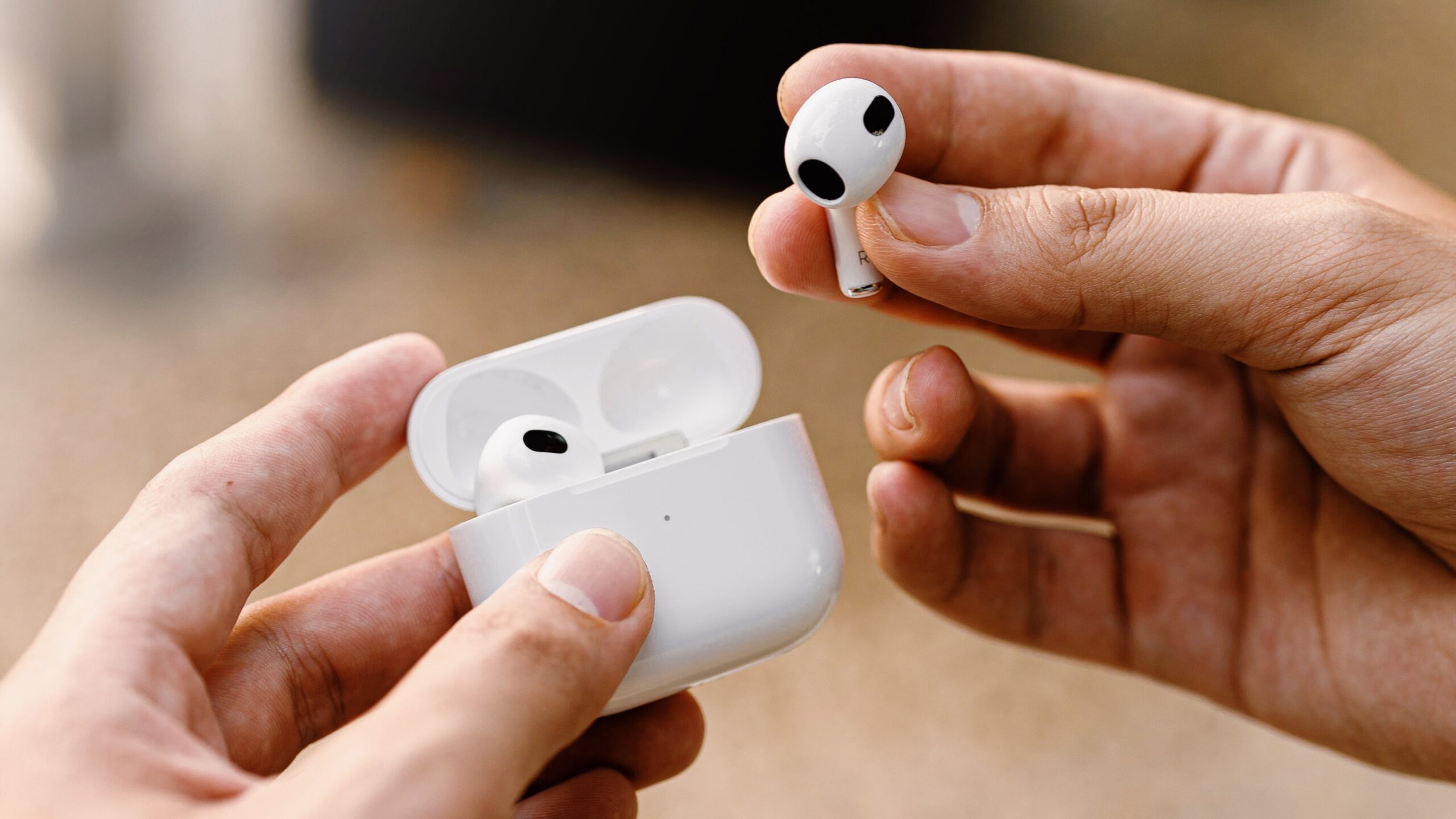 Photo of person holding AirPods