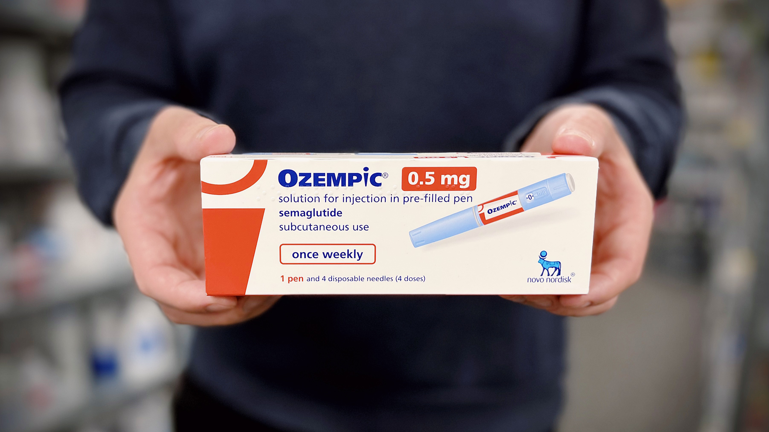 Photo of person holding Ozempic drug box