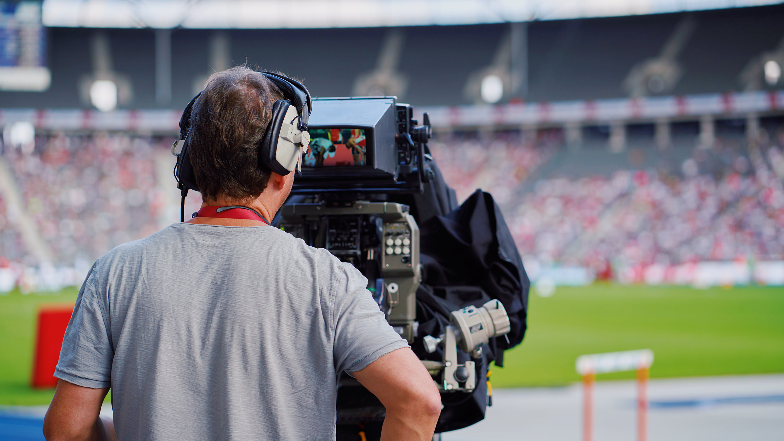 Photo of a sports media cameraman