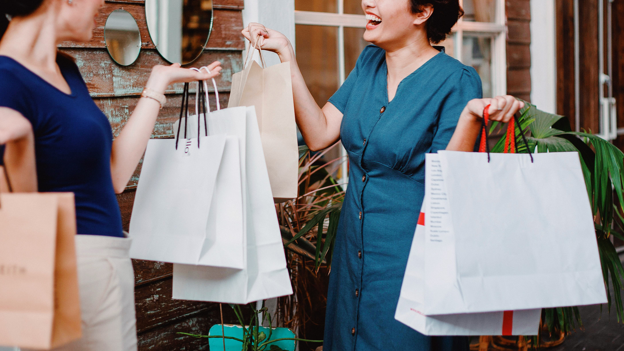 Photo of two people holding several shopping bags