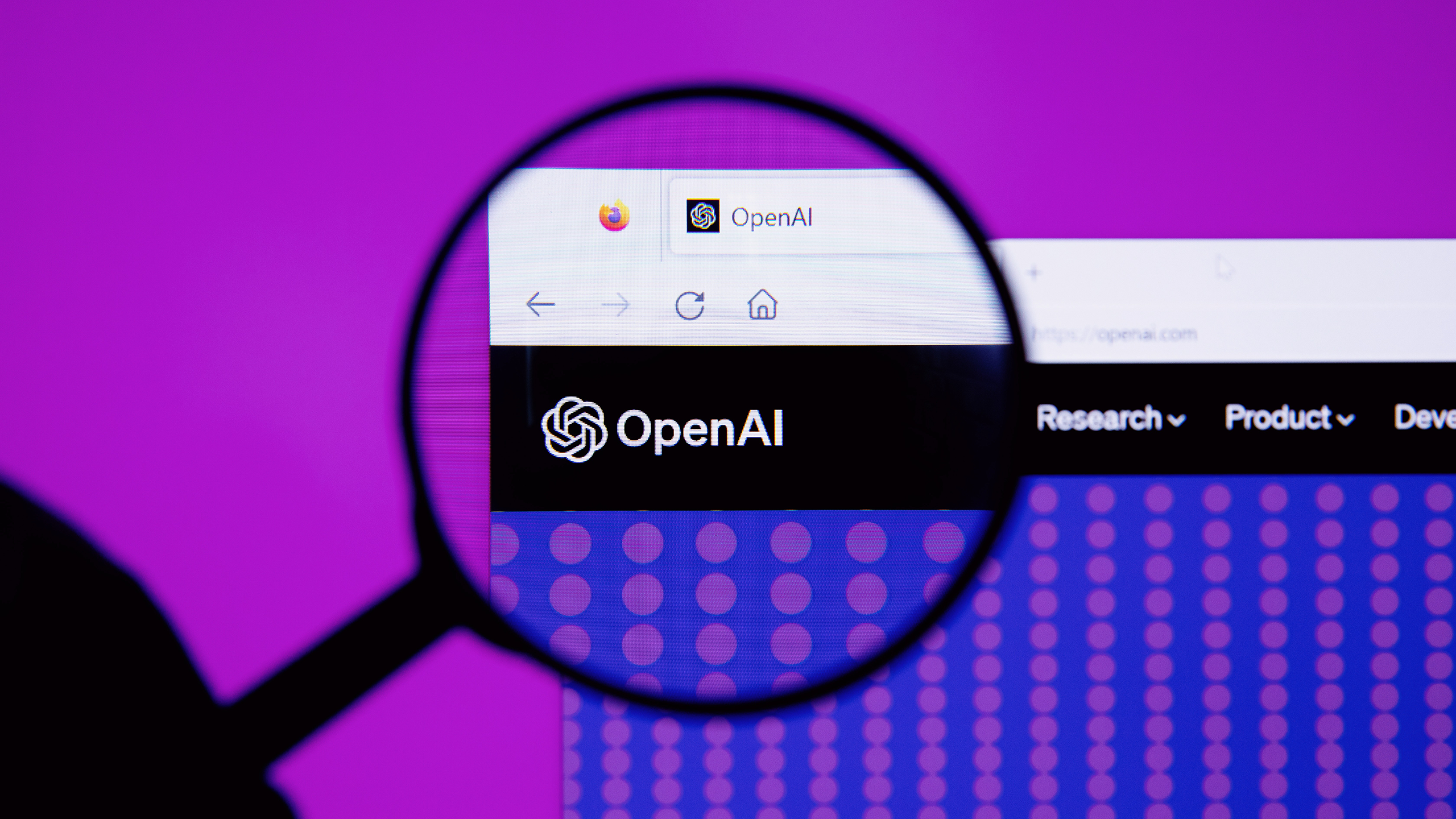 Photo of the OpenAI logo with a magnifying glass on top of it