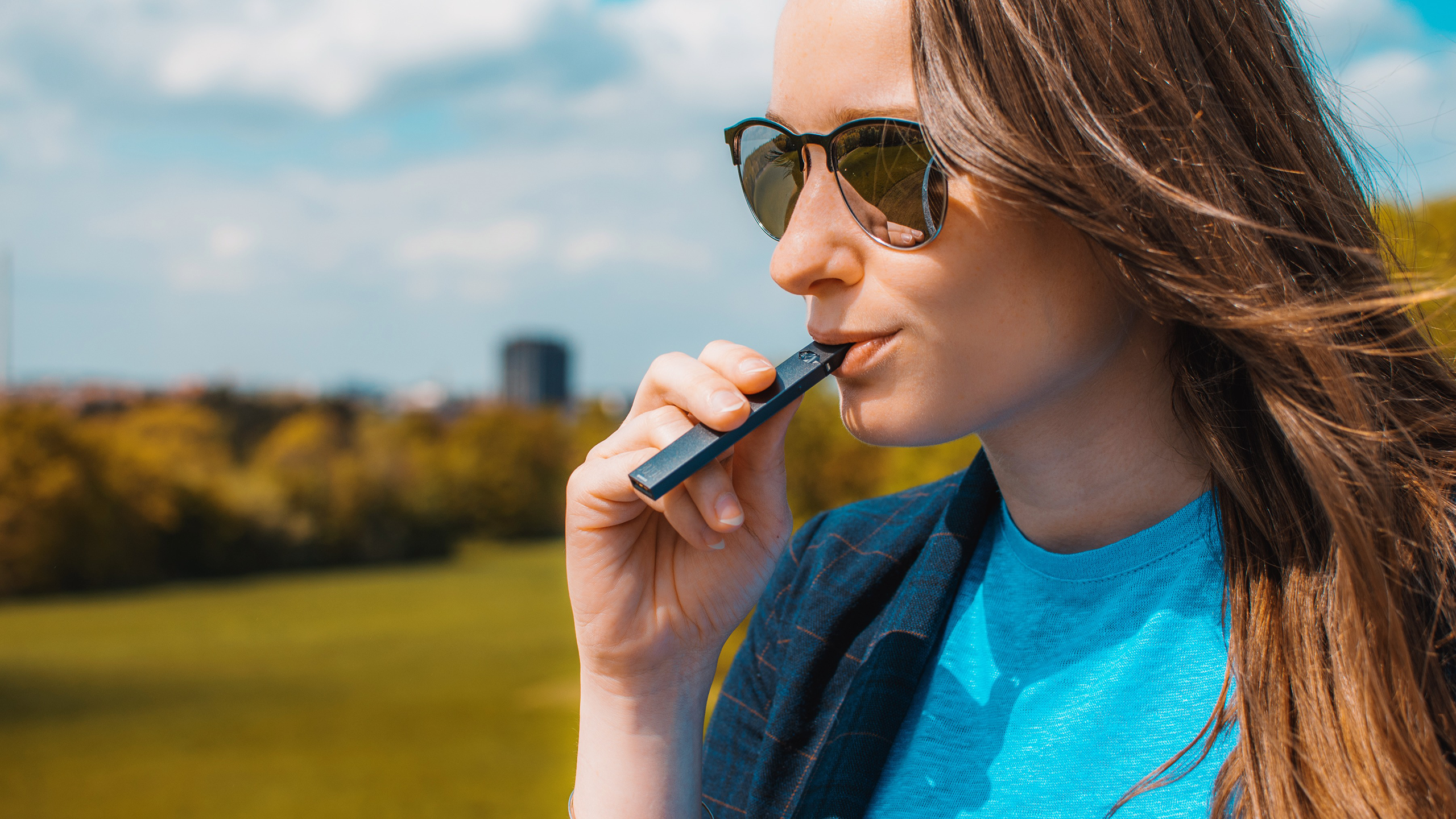 Photo of a person using a JUUL
