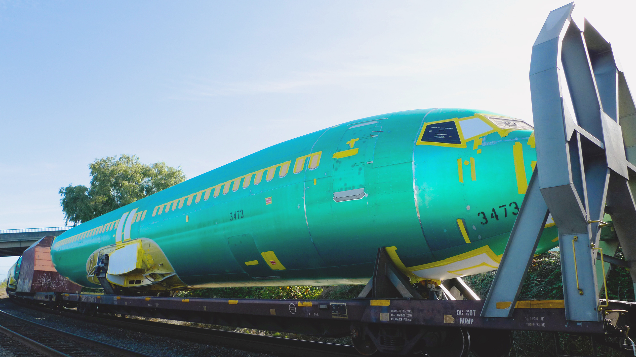 Photo of parts of a Boeing plane being transported on a train
