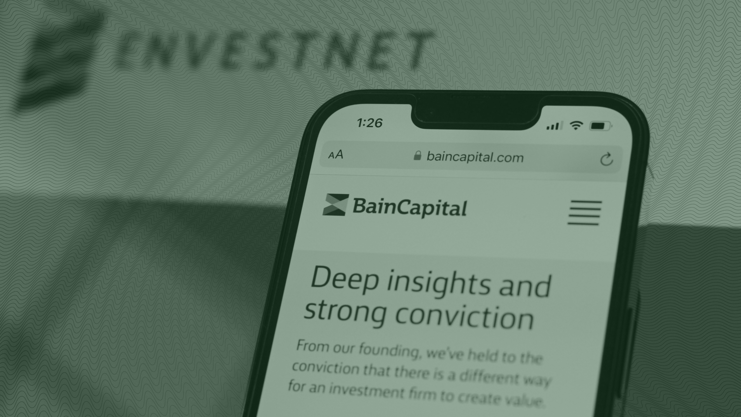 Photo of the Bain Capital website and Envestnet logo