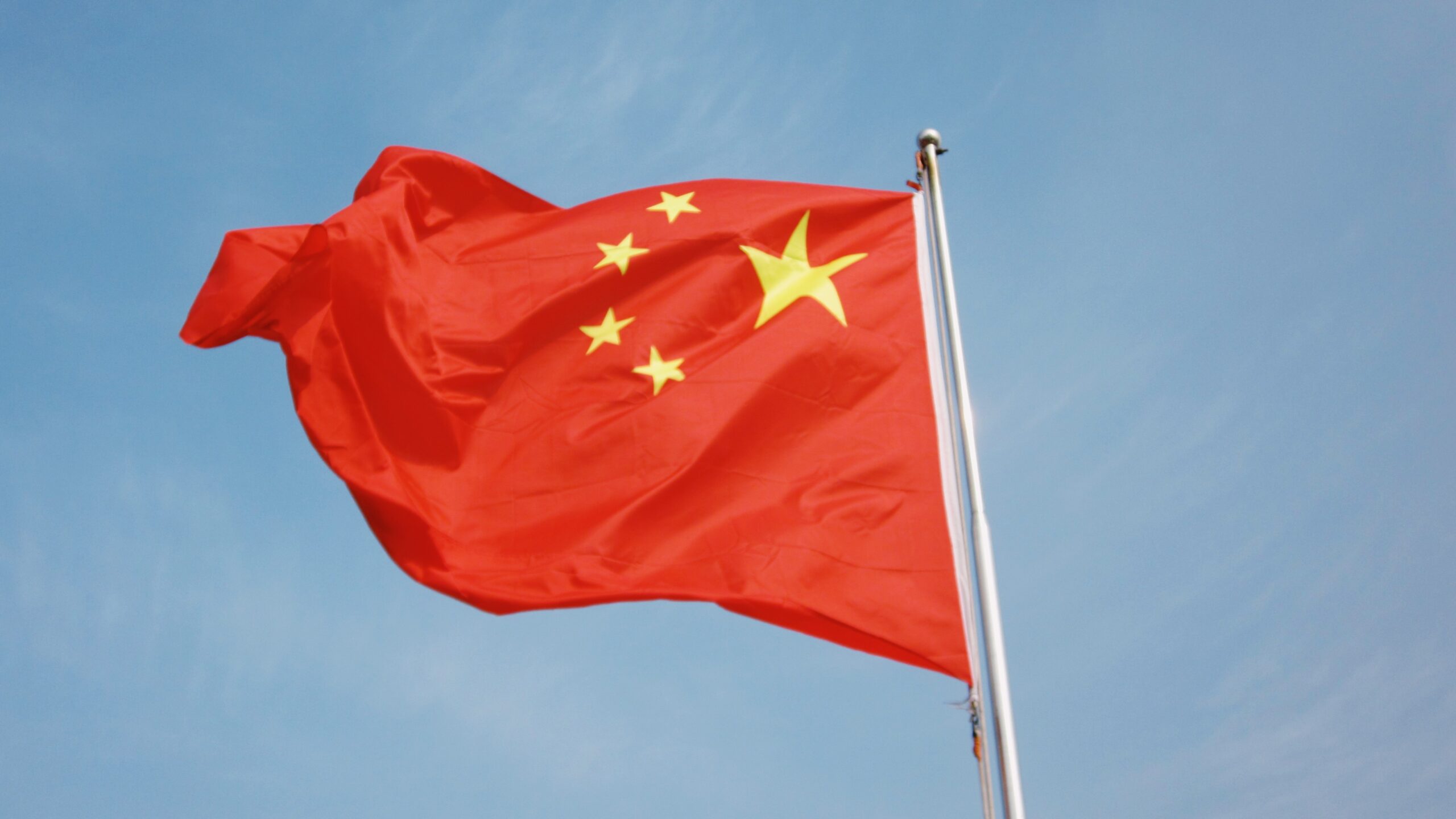 Chinese flag on a flag pole waving in the wind