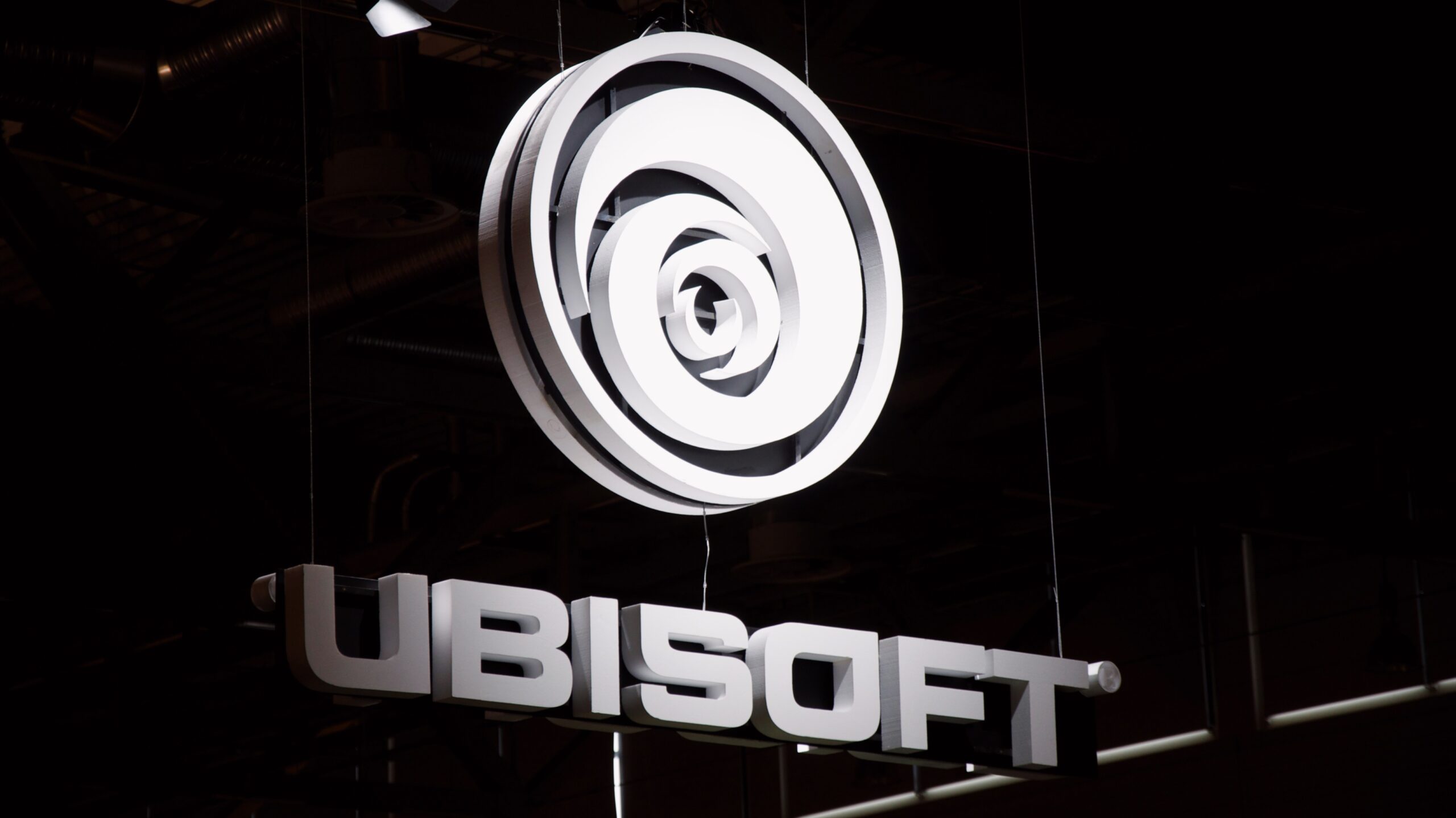 Big white Ubisoft logo in white hanging above a stage