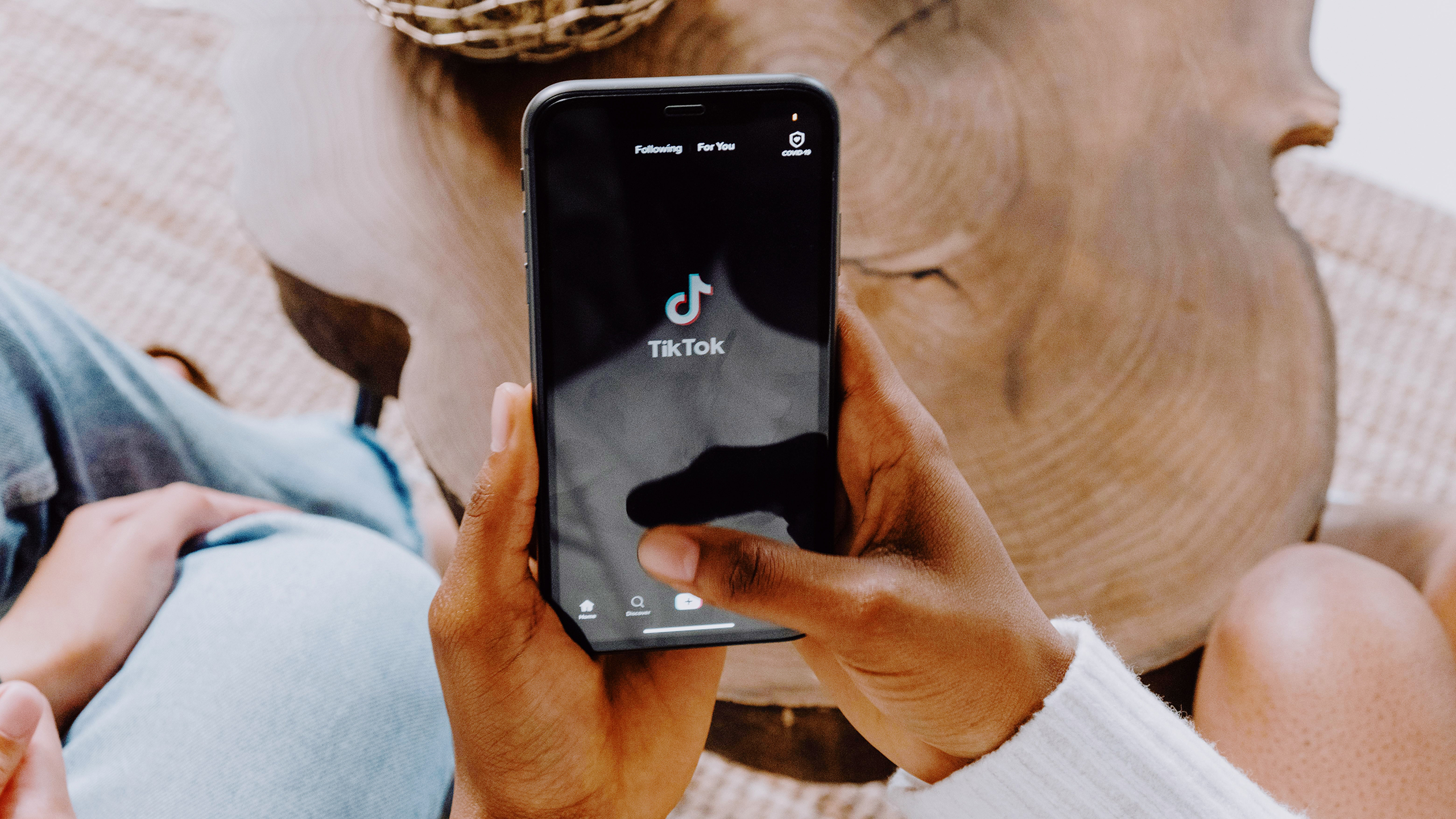 Photo of a person using TikTok on an iPhone