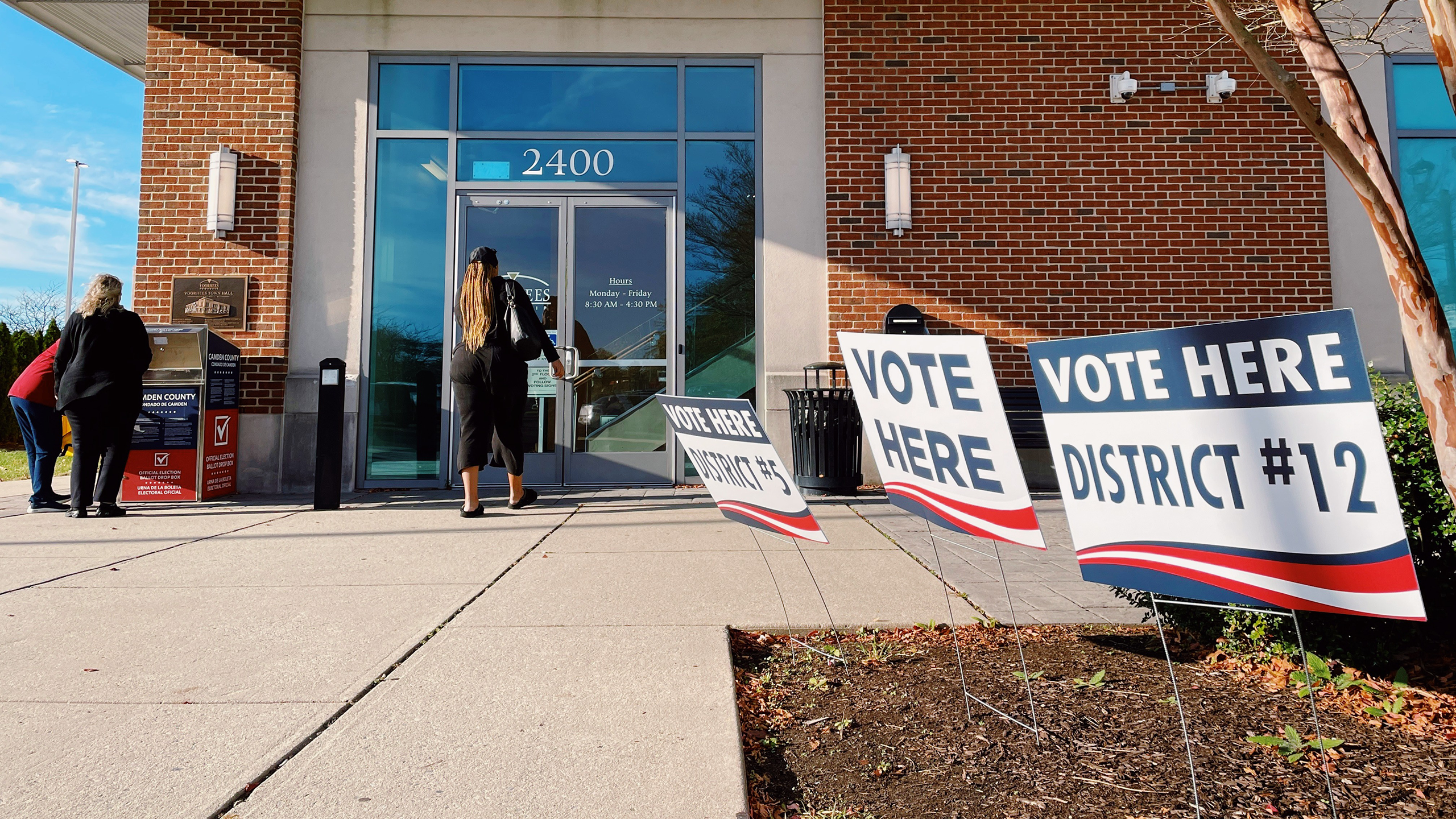 Photo of a voting center with a ballot drop box