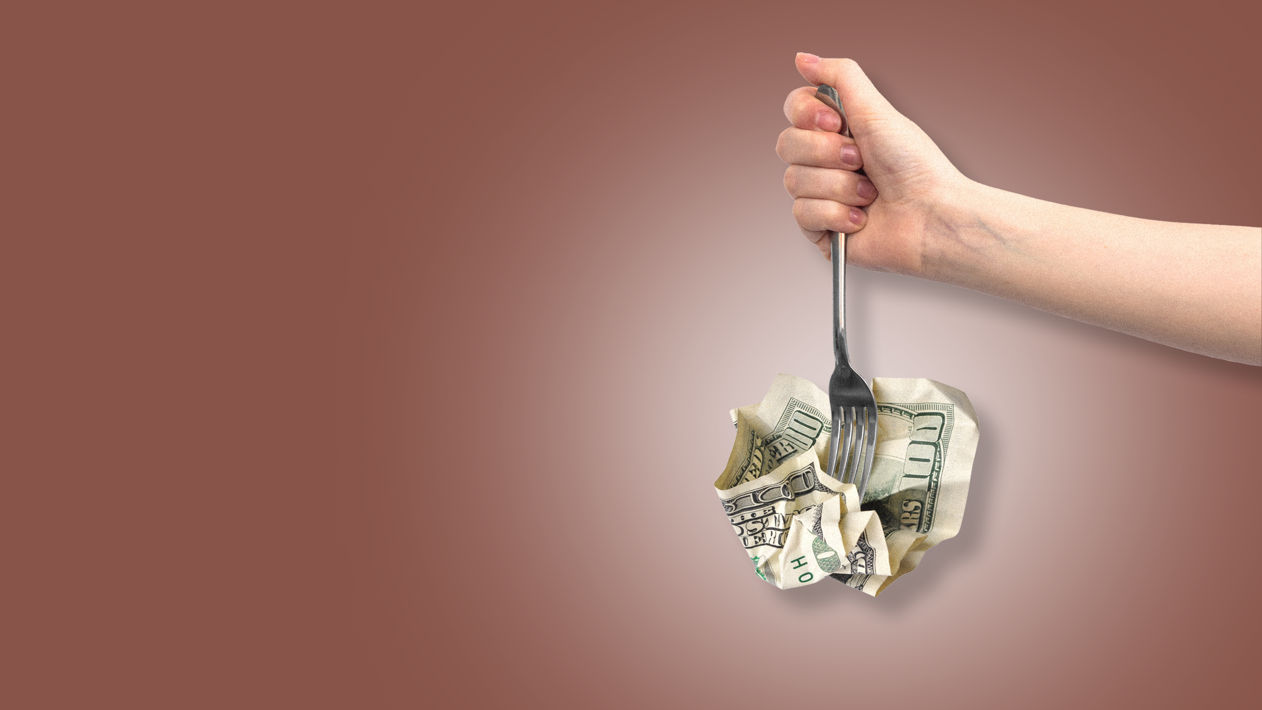 Photo illustration of a hand holding a fork stabbing a crumpled 100 dollar bill