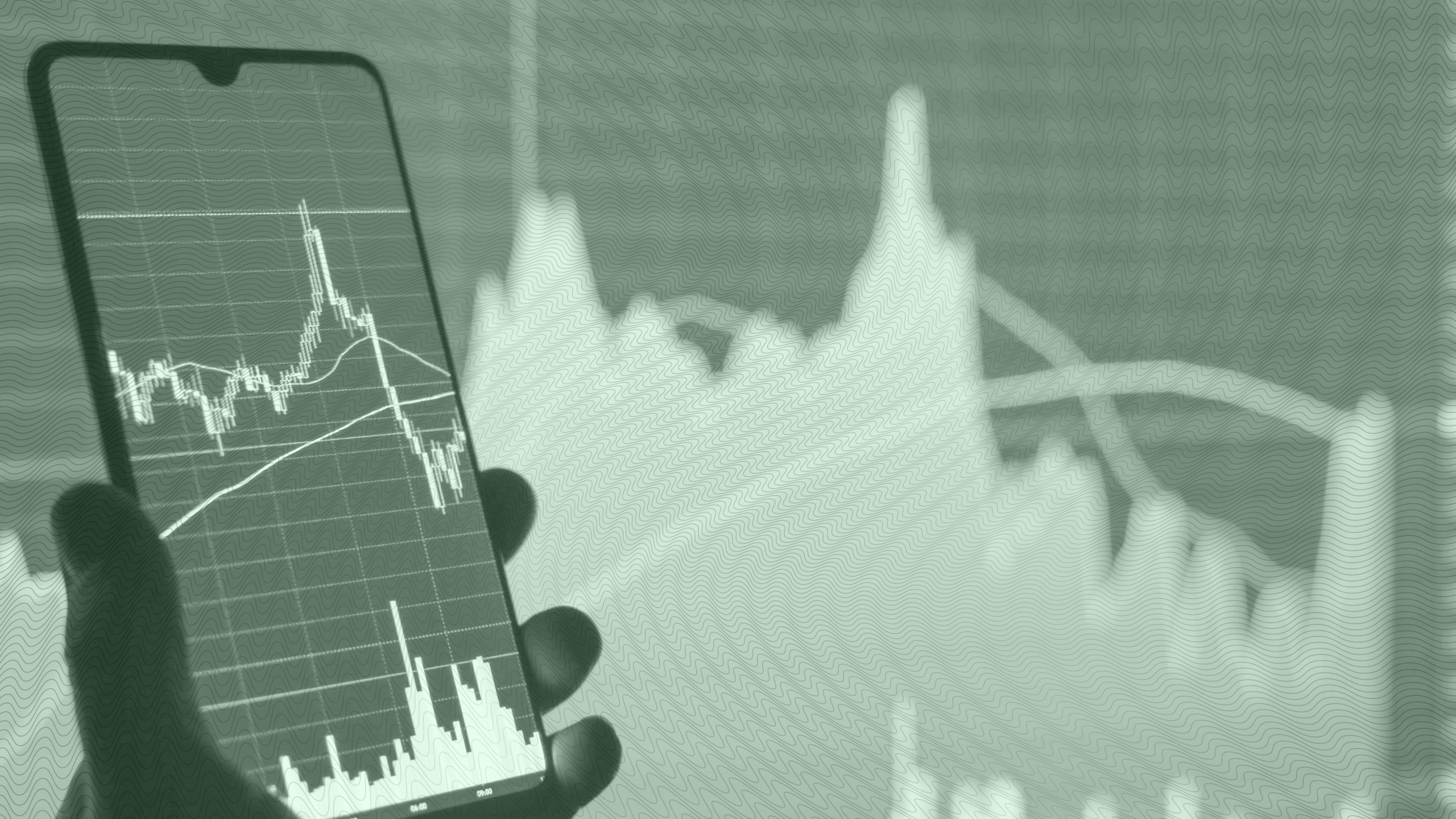 Photo of a person looking at a stock chart on their phone