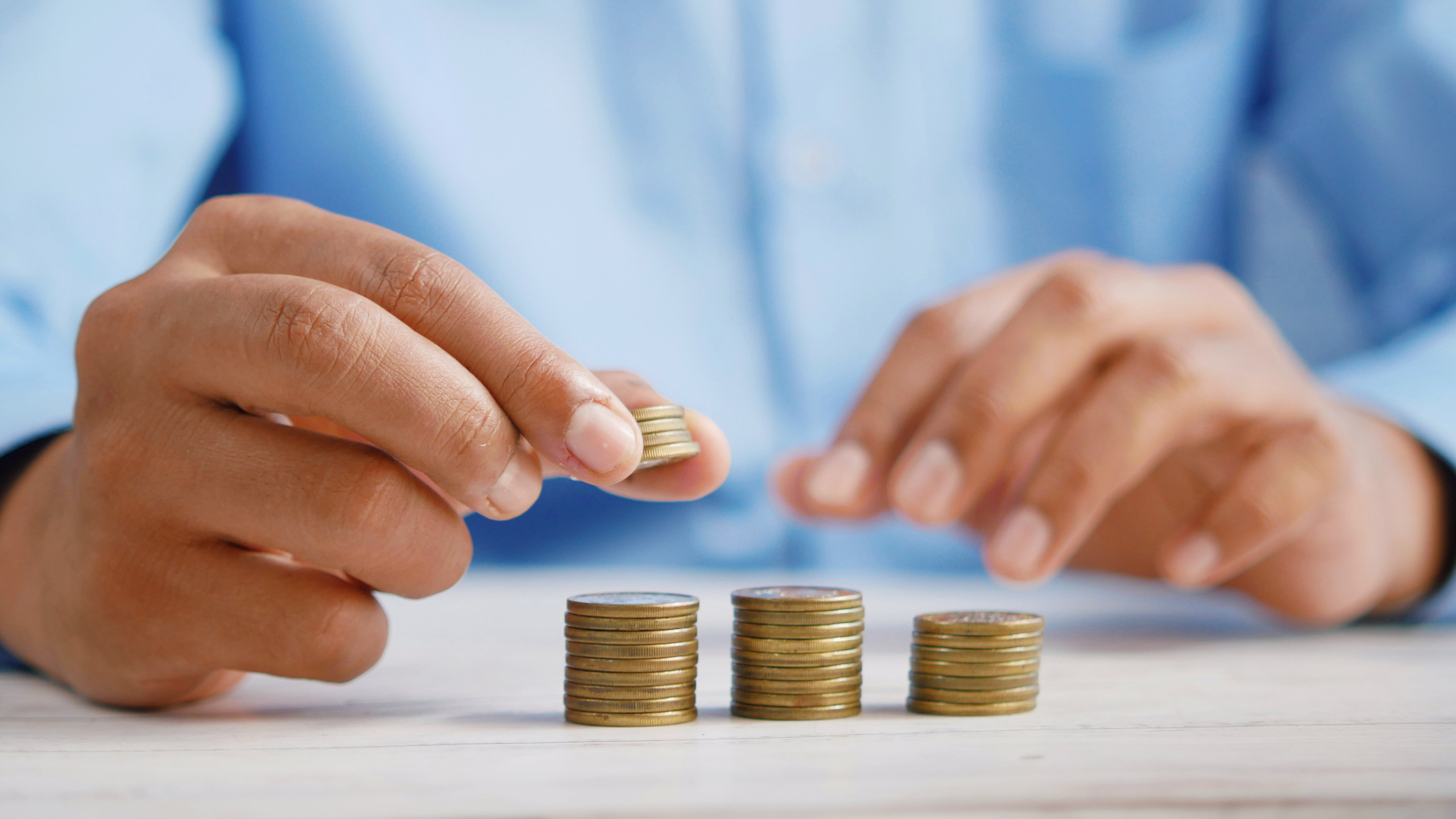 Photo of a person counting money for a budget