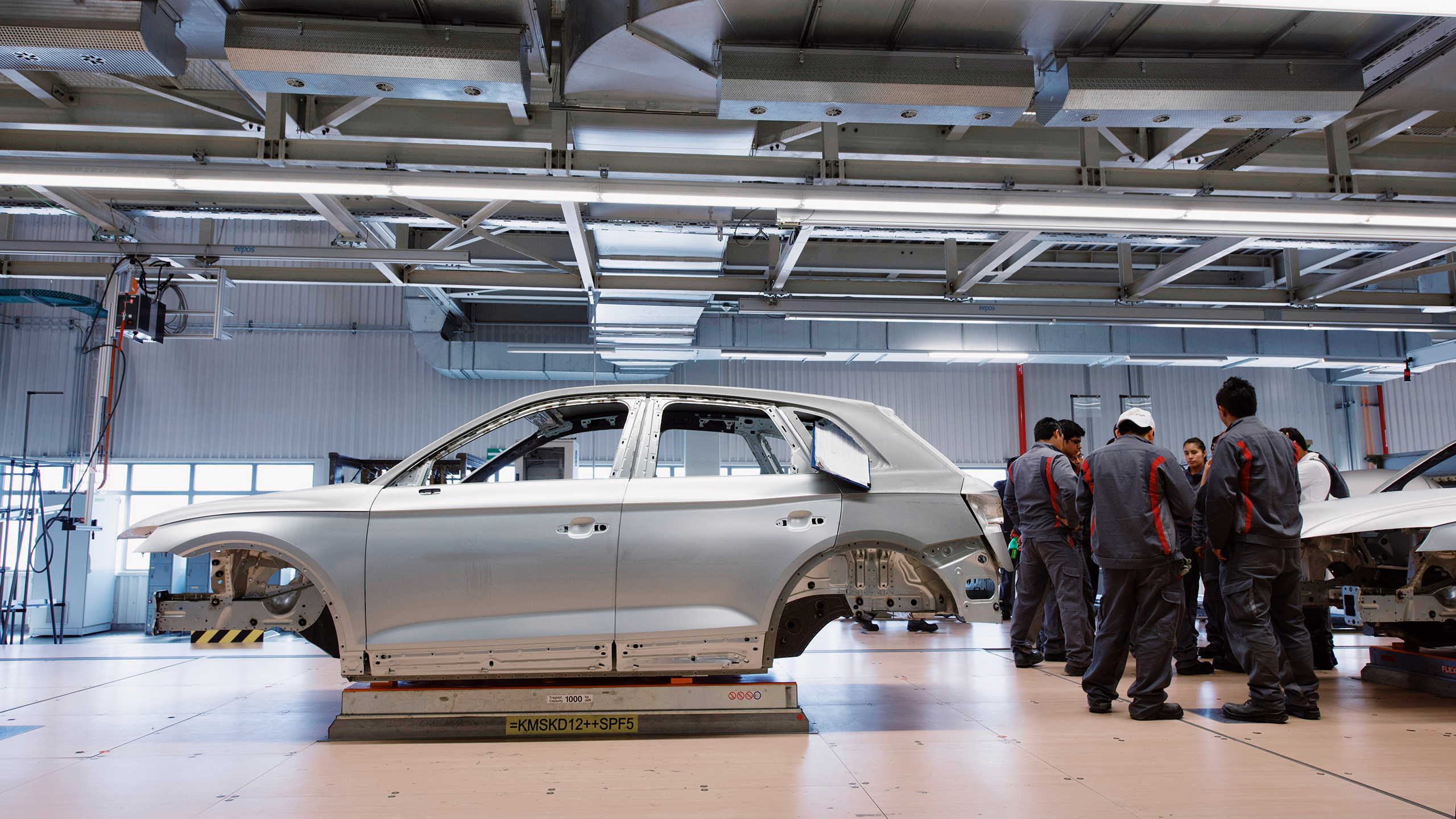 Photo of workers in an auto factory