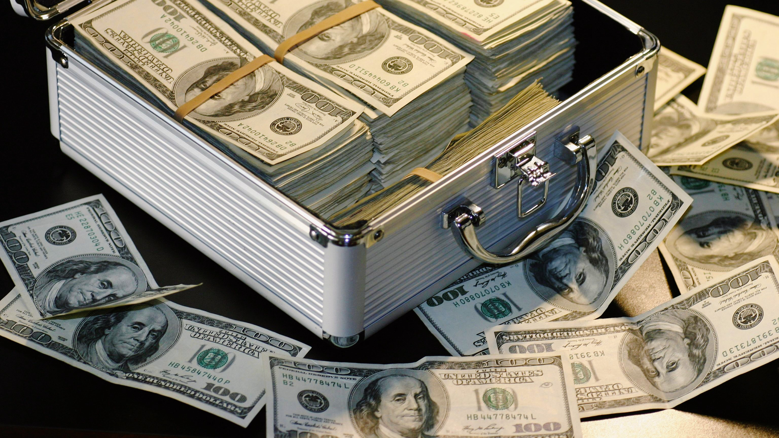 Photo of a briefcase of one hundred dollar bills