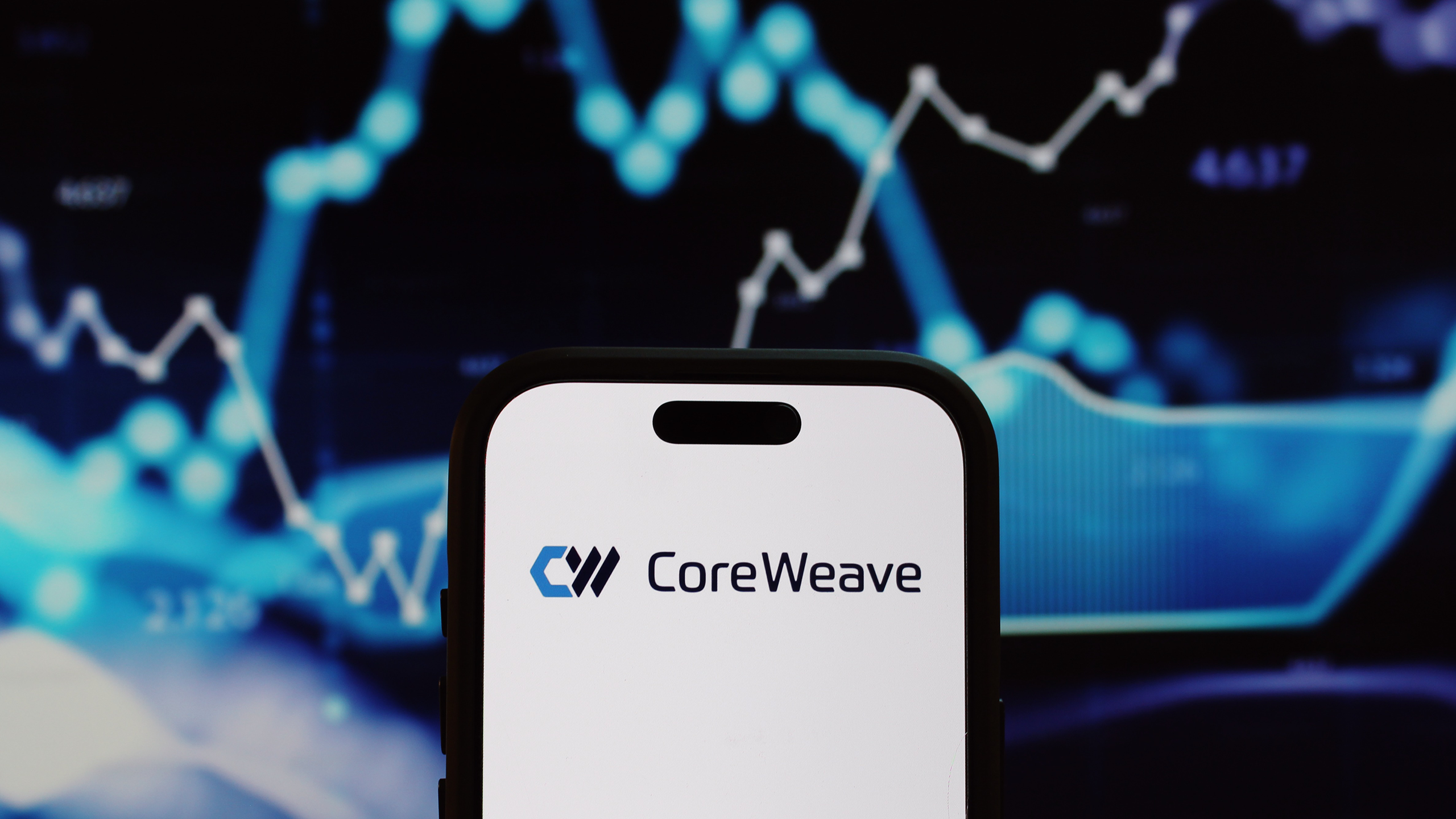 Photo of CoreWeave logo on a phone