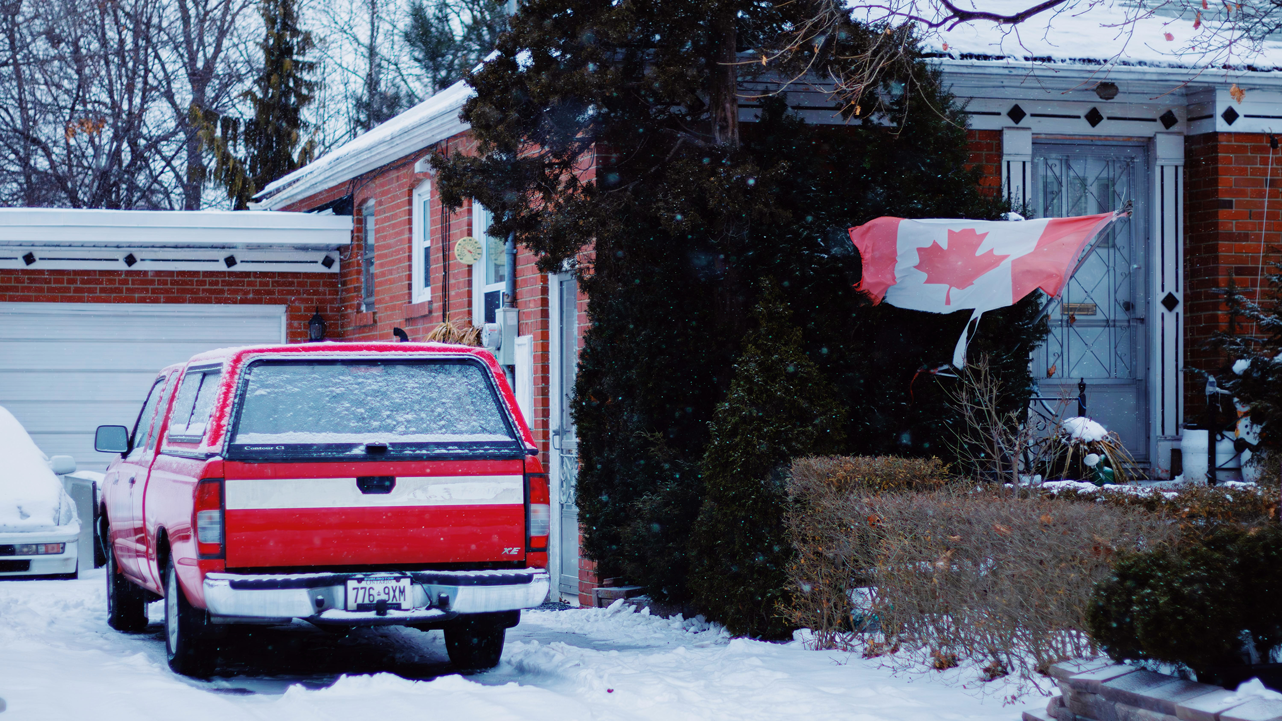 Photo of a house with a Canadian flag hanging outside