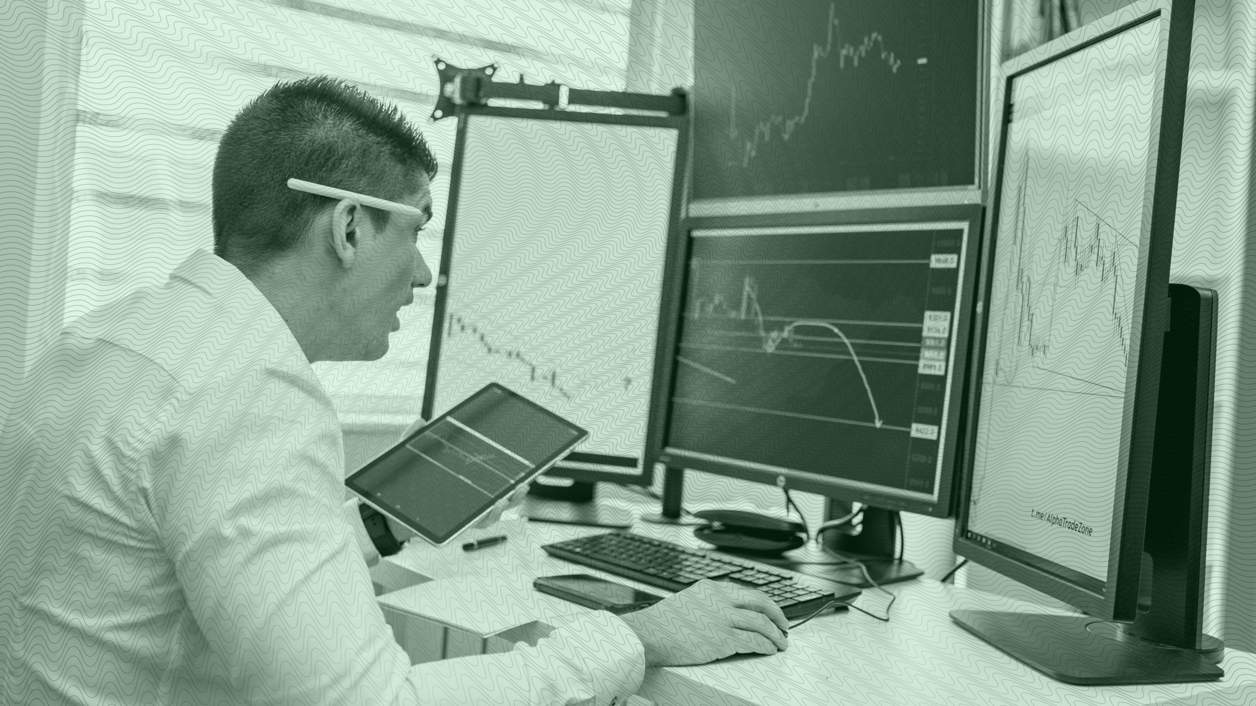 Photo of a person looking at stock charts on multiple screens