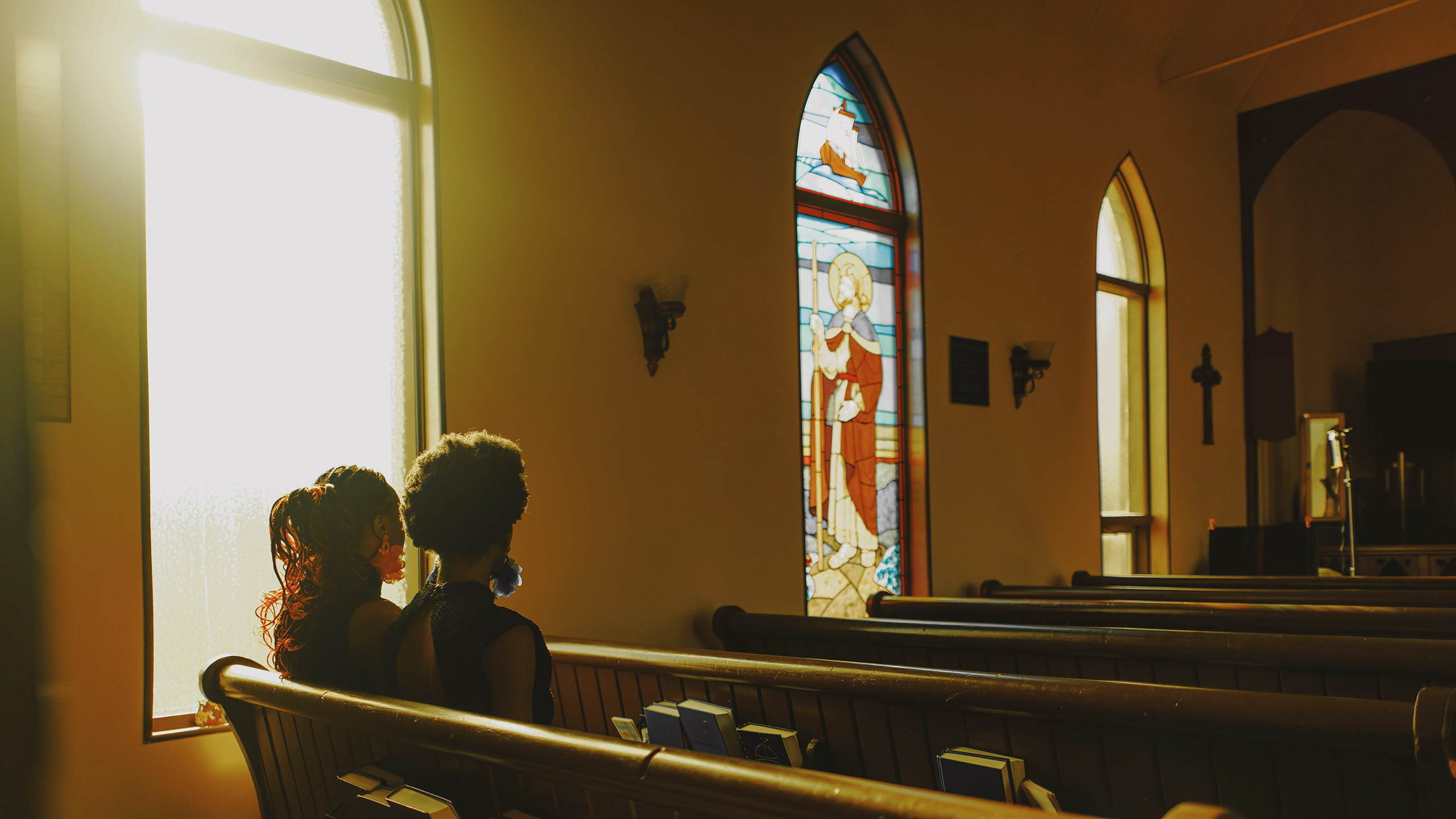 Photo of two people sitting inside of a church