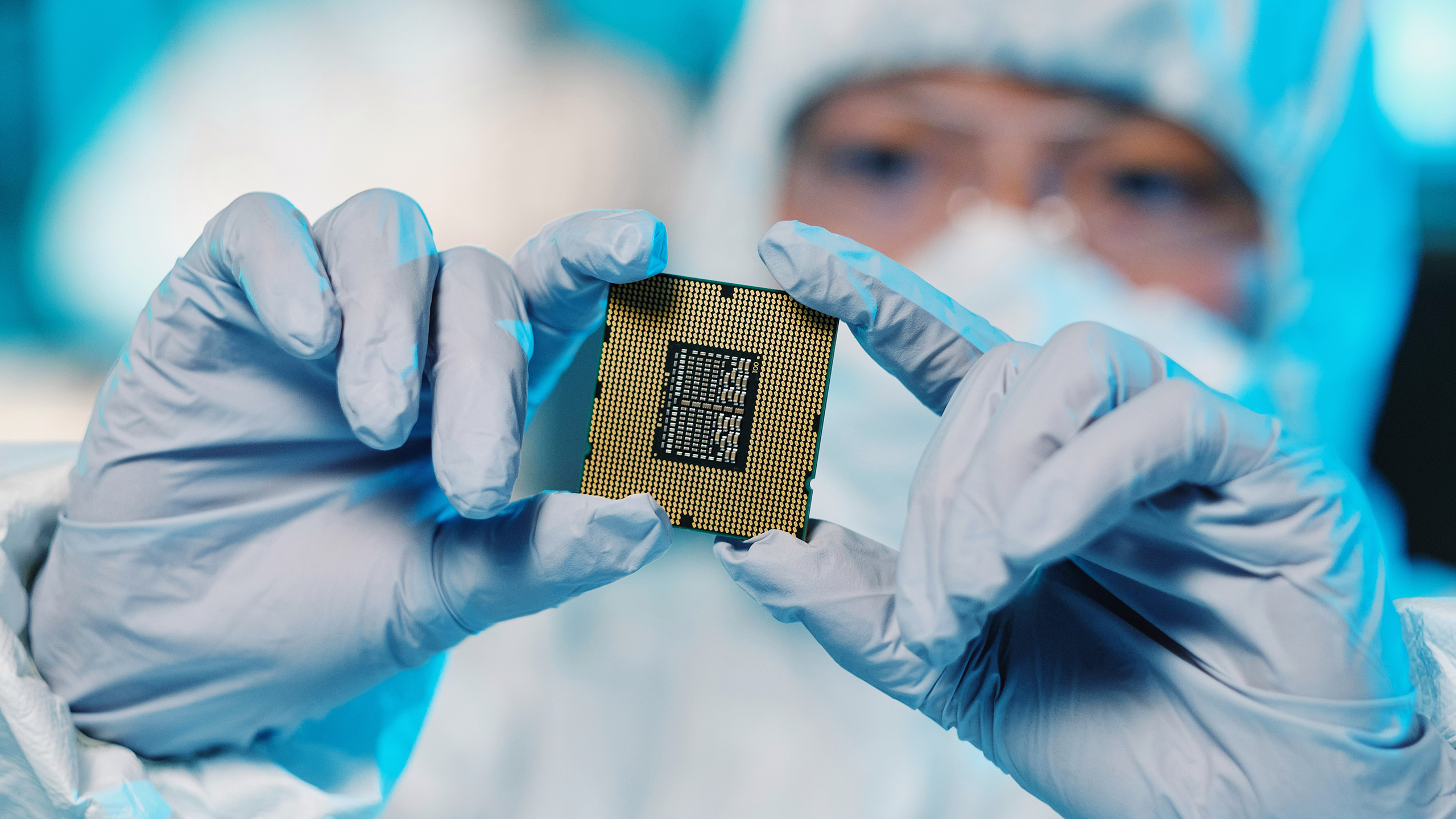 Photo of a person holding up a semiconductor chip