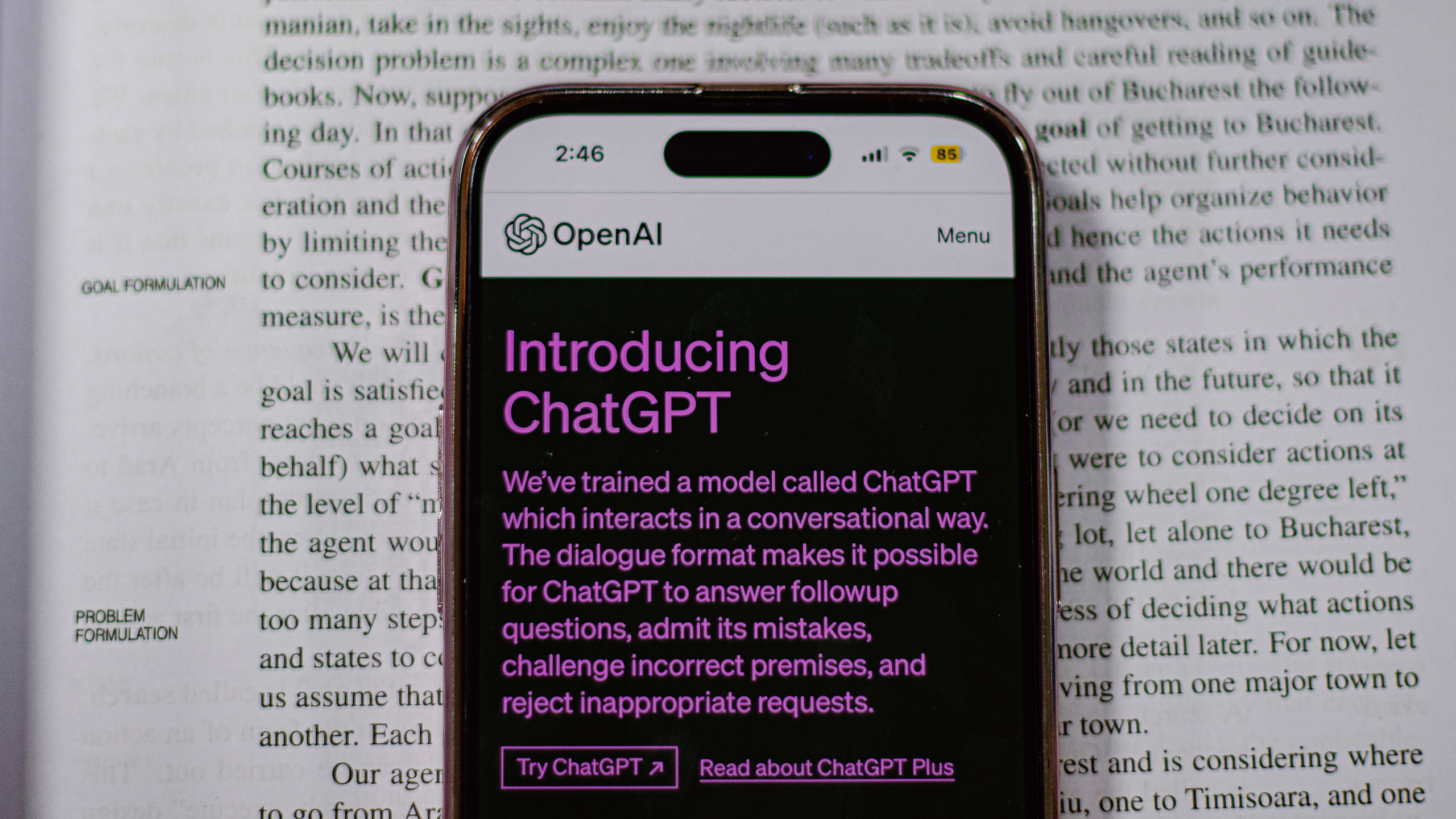Photo of ChatGPT on a phone on top of a textbook