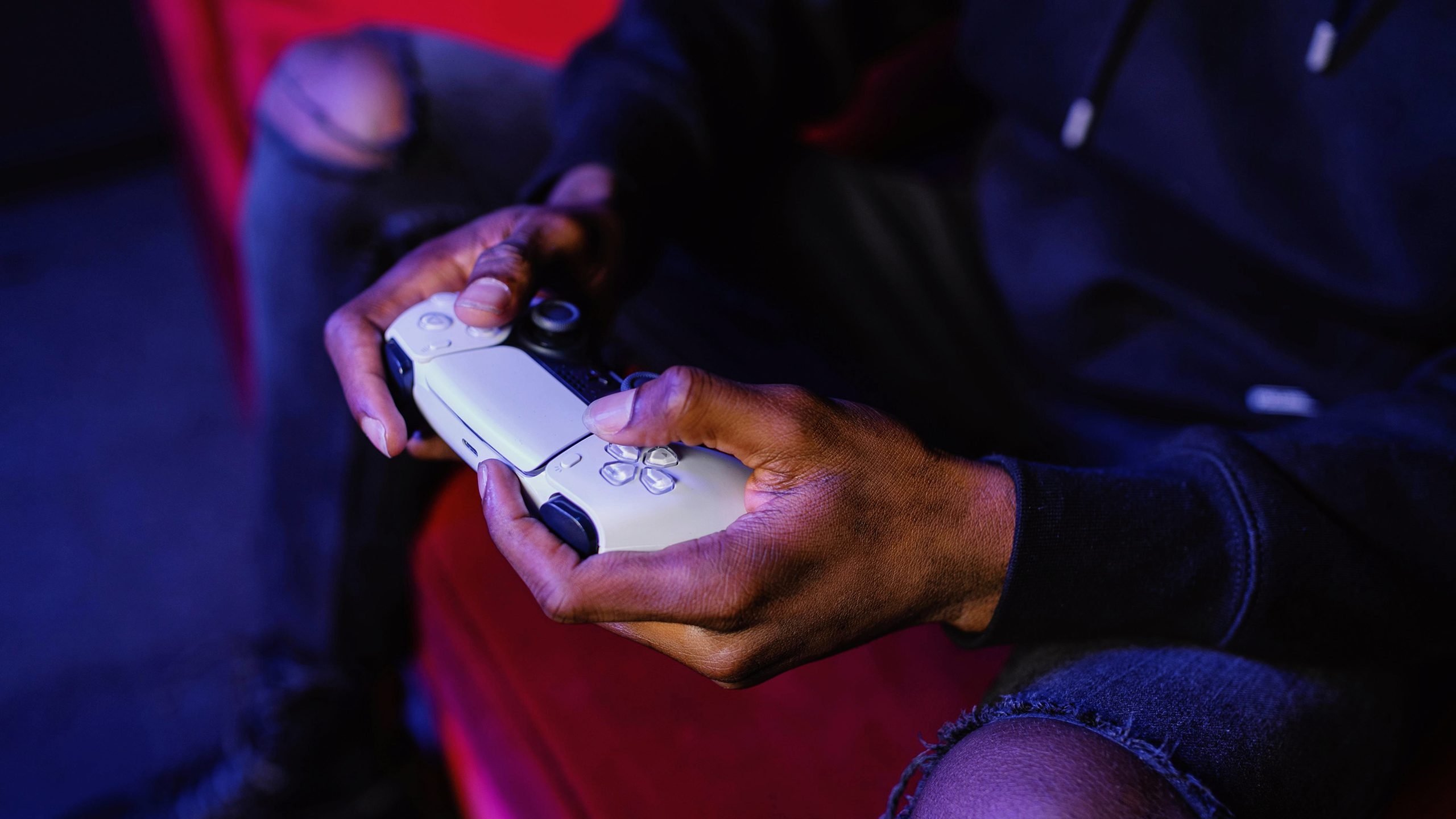 Photo of a person holding a PS5 controller