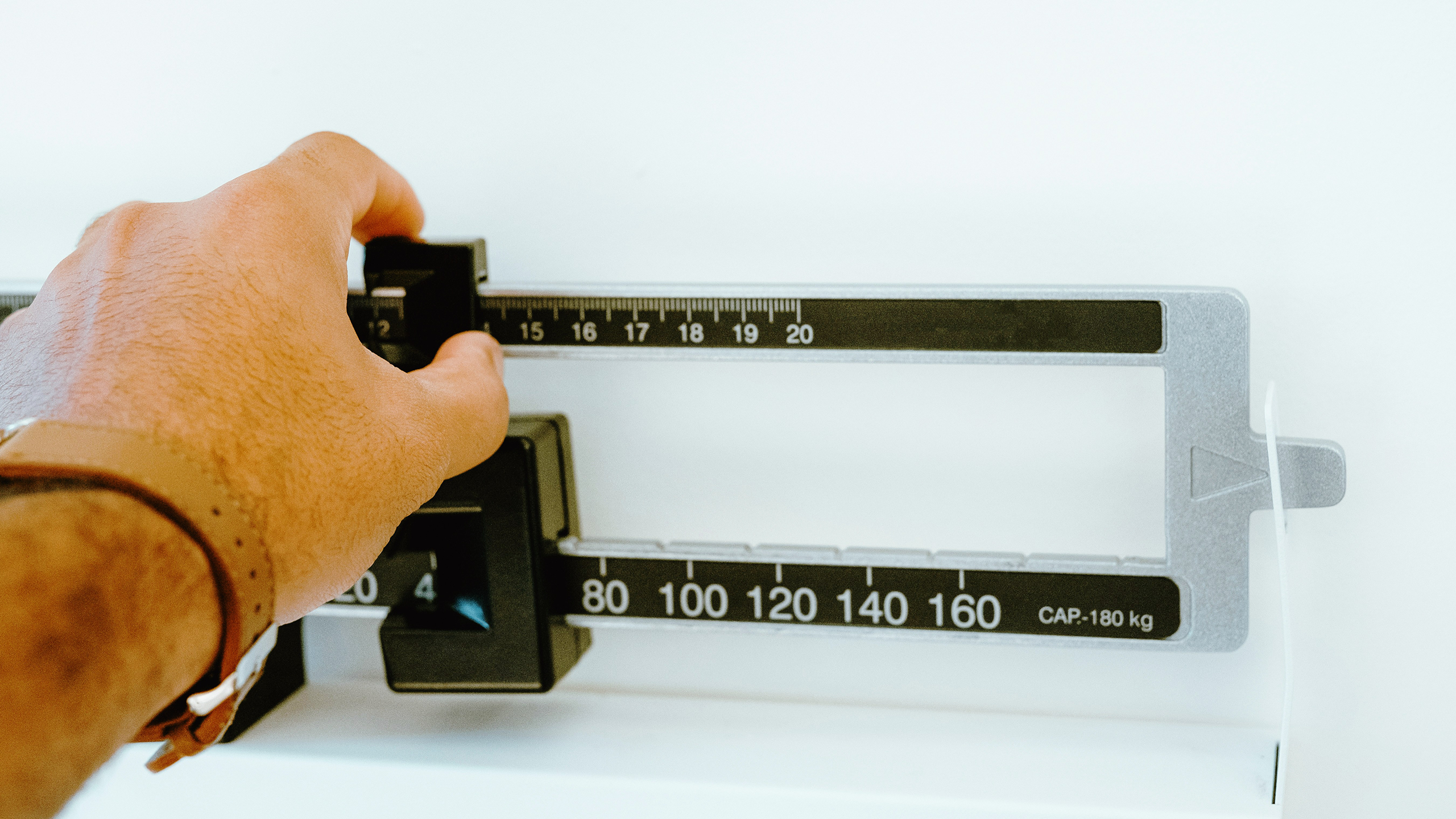 Photo of a person measuring themselves on a scale