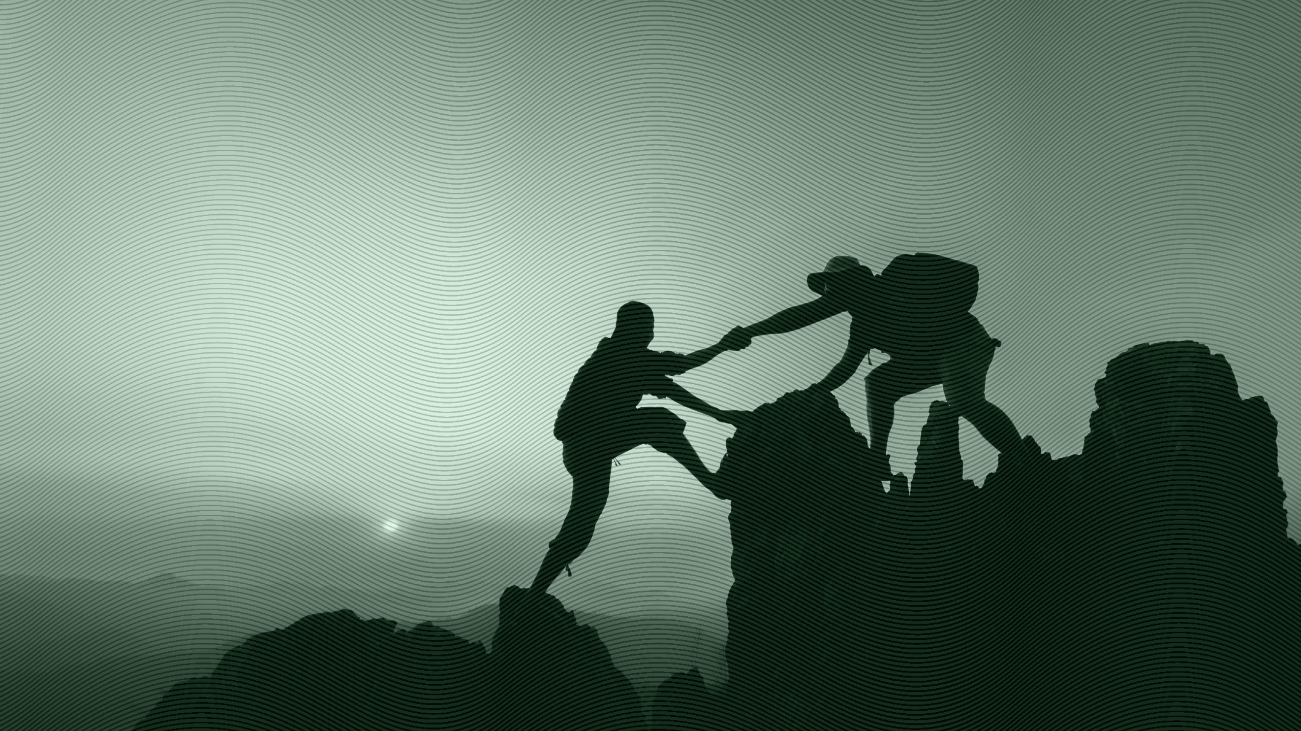 Photo of a person helping another person climb