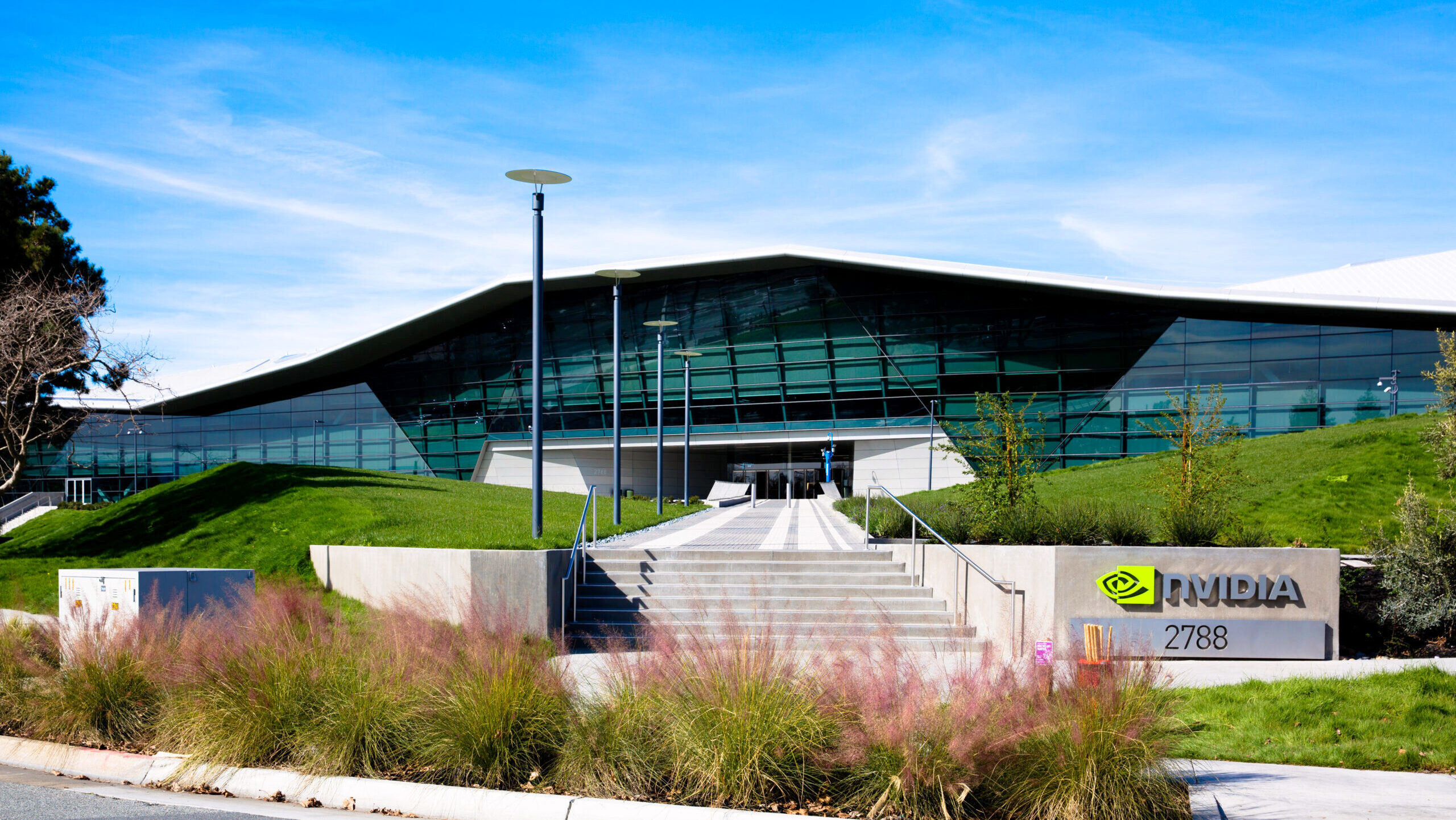 Nvidia's headquarters in Santa Clara, California are shown against a bright, blue sky.