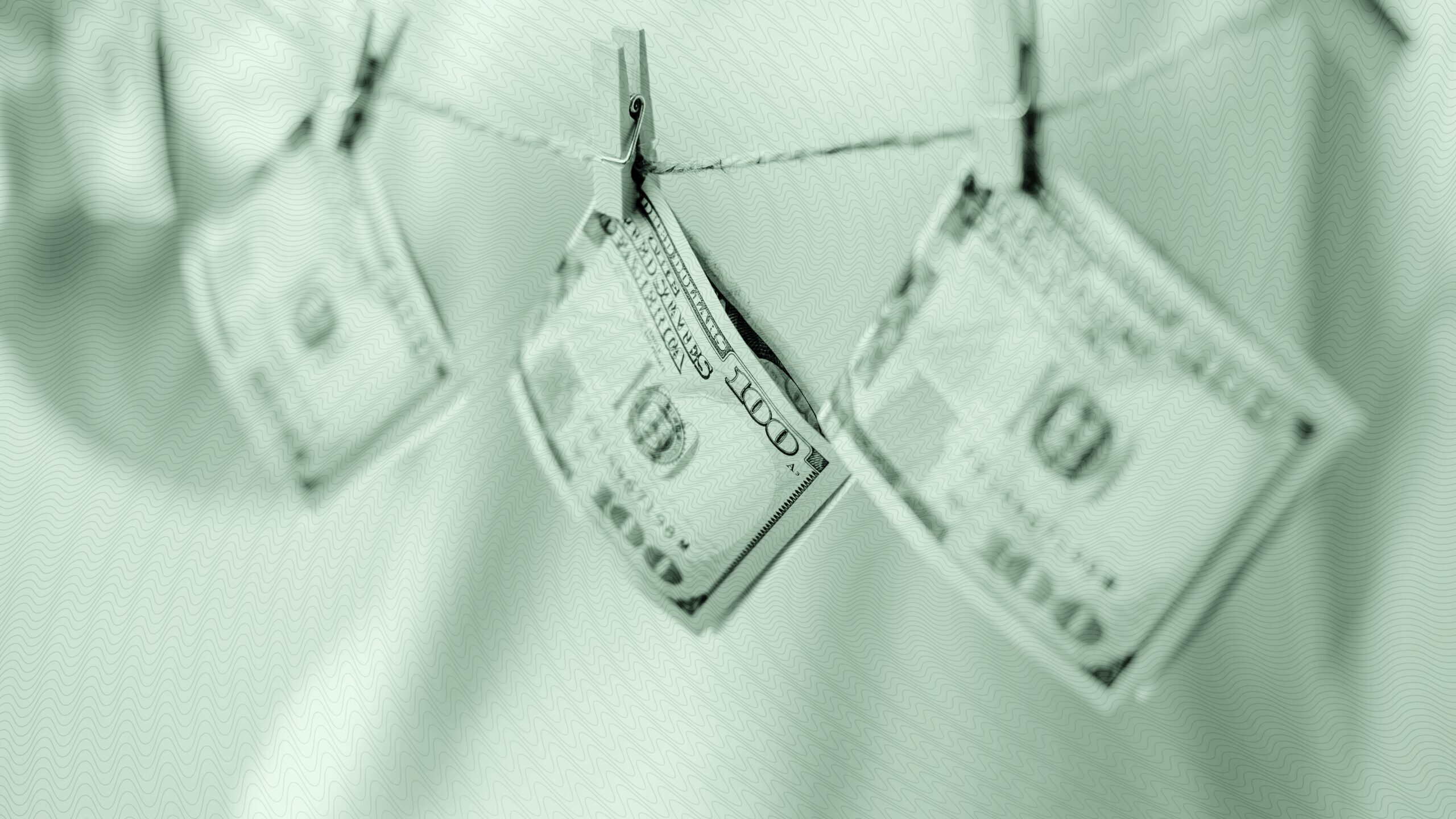 Money hanging from a clothesline.