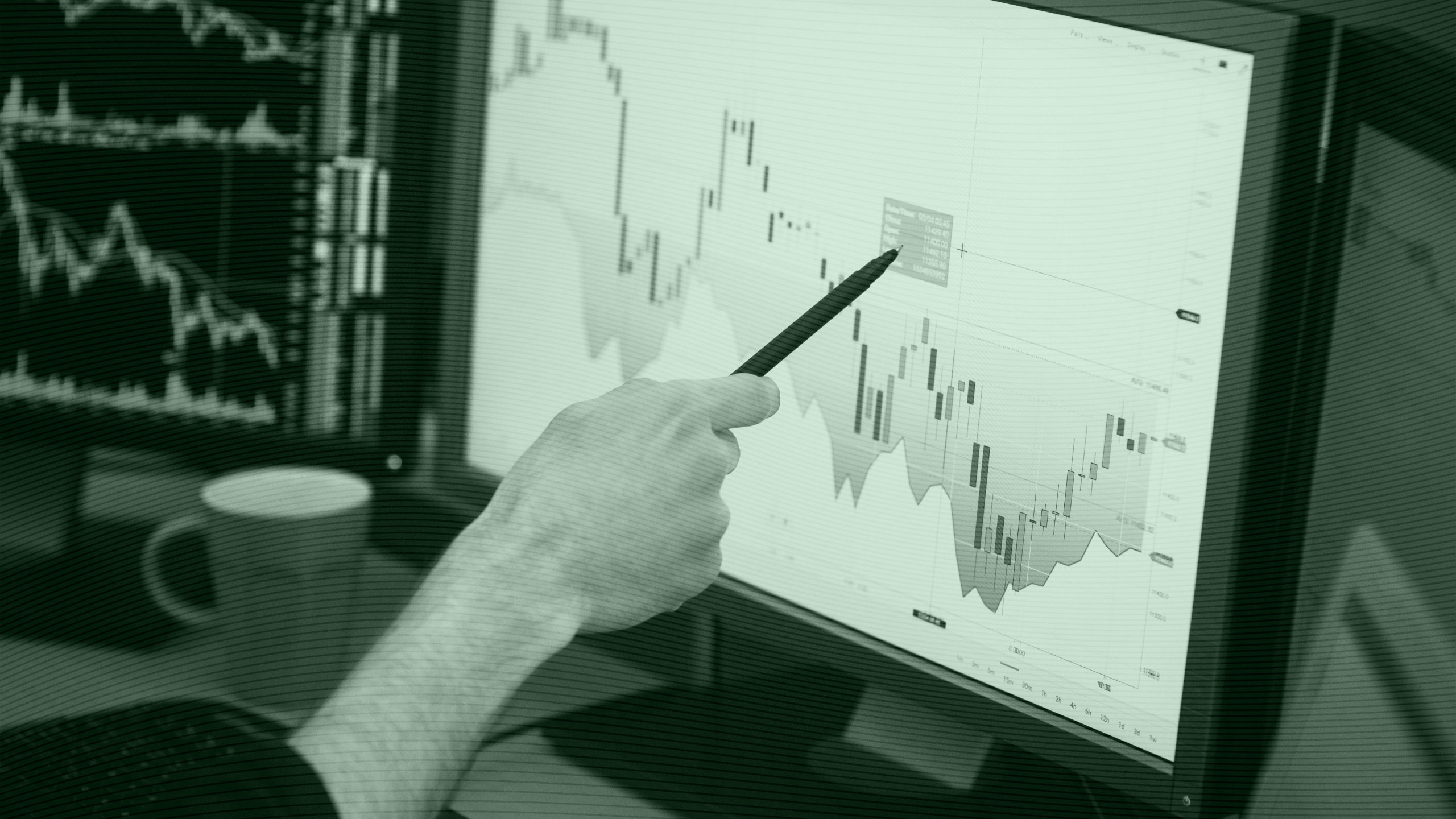 Photo of a stock trader pointing at a chart