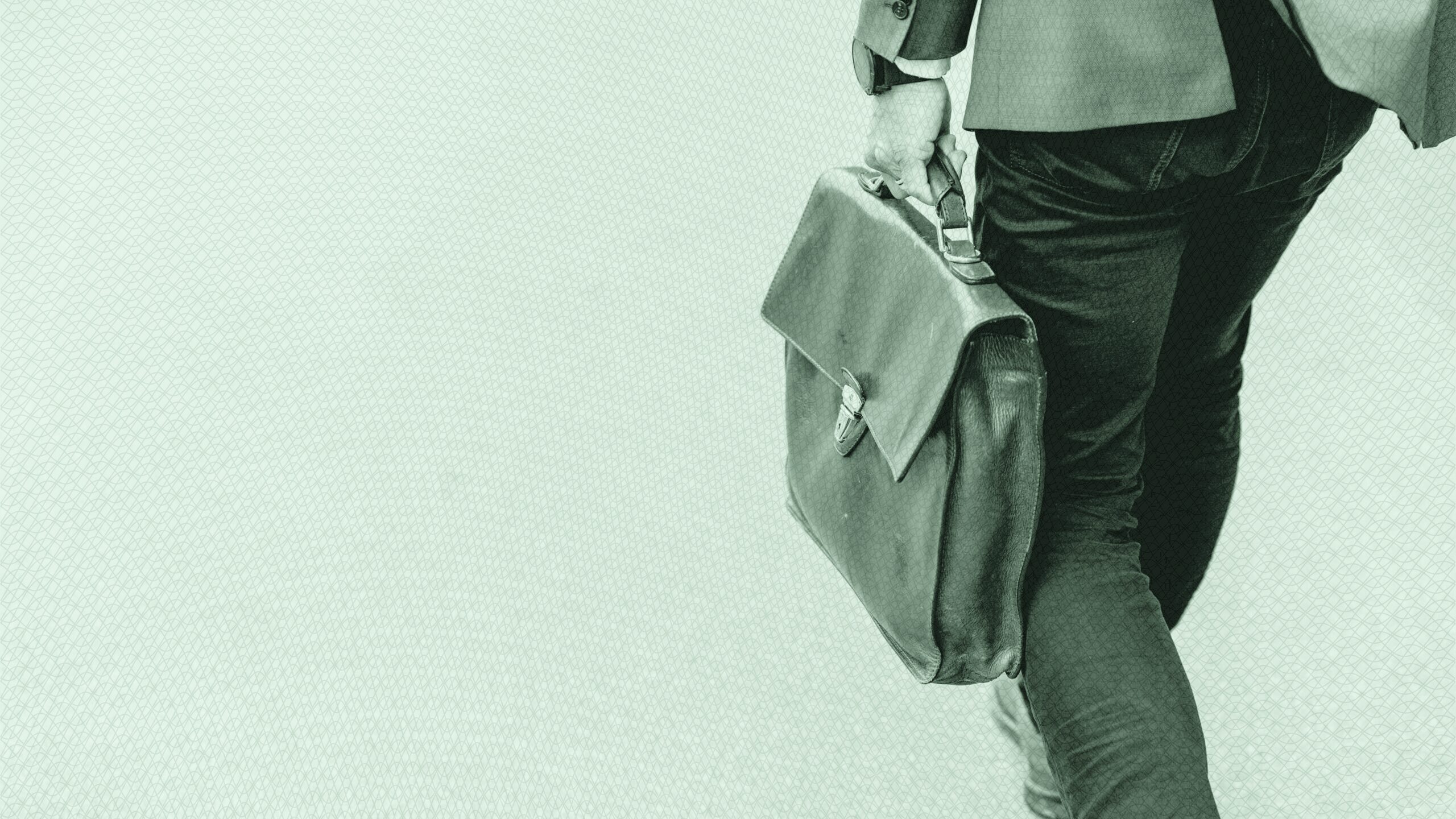 A person walking with a brief case.