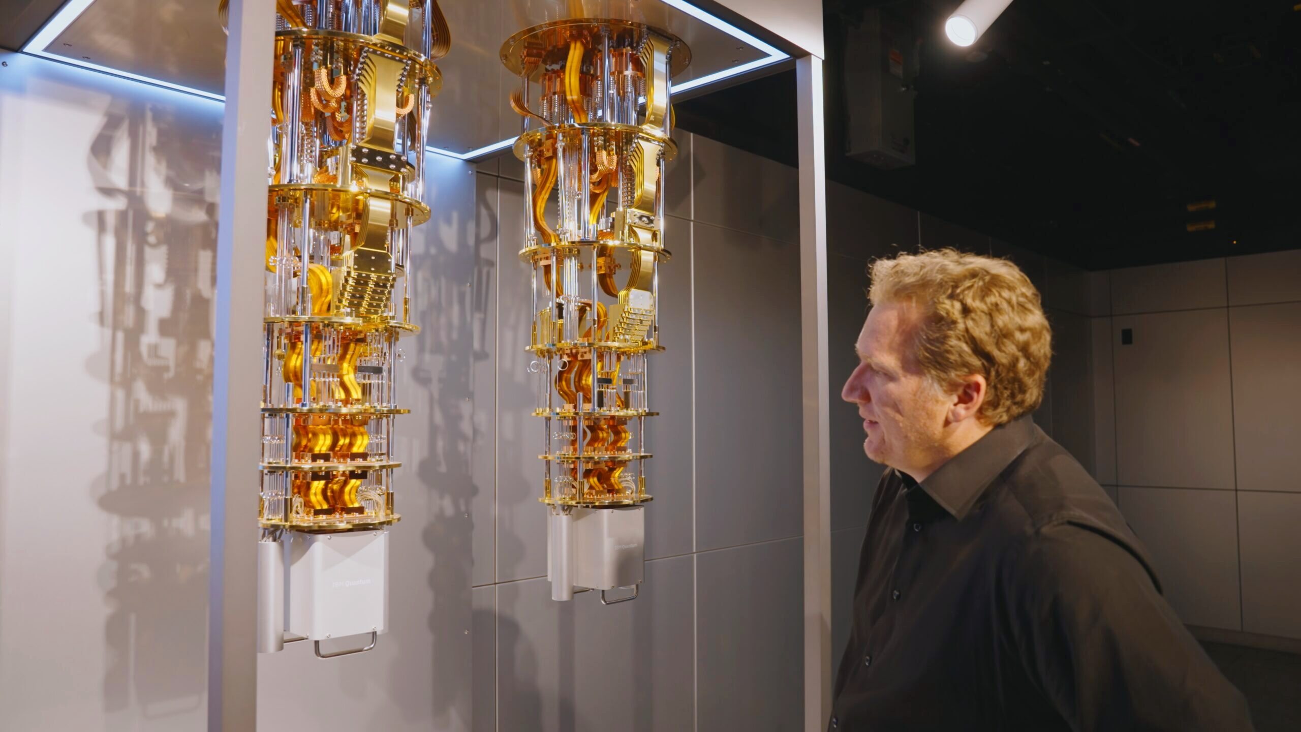 A person looks on at the the IBM quantum computer used in a trial by HSBC to assess its performance analyzing bond trading.