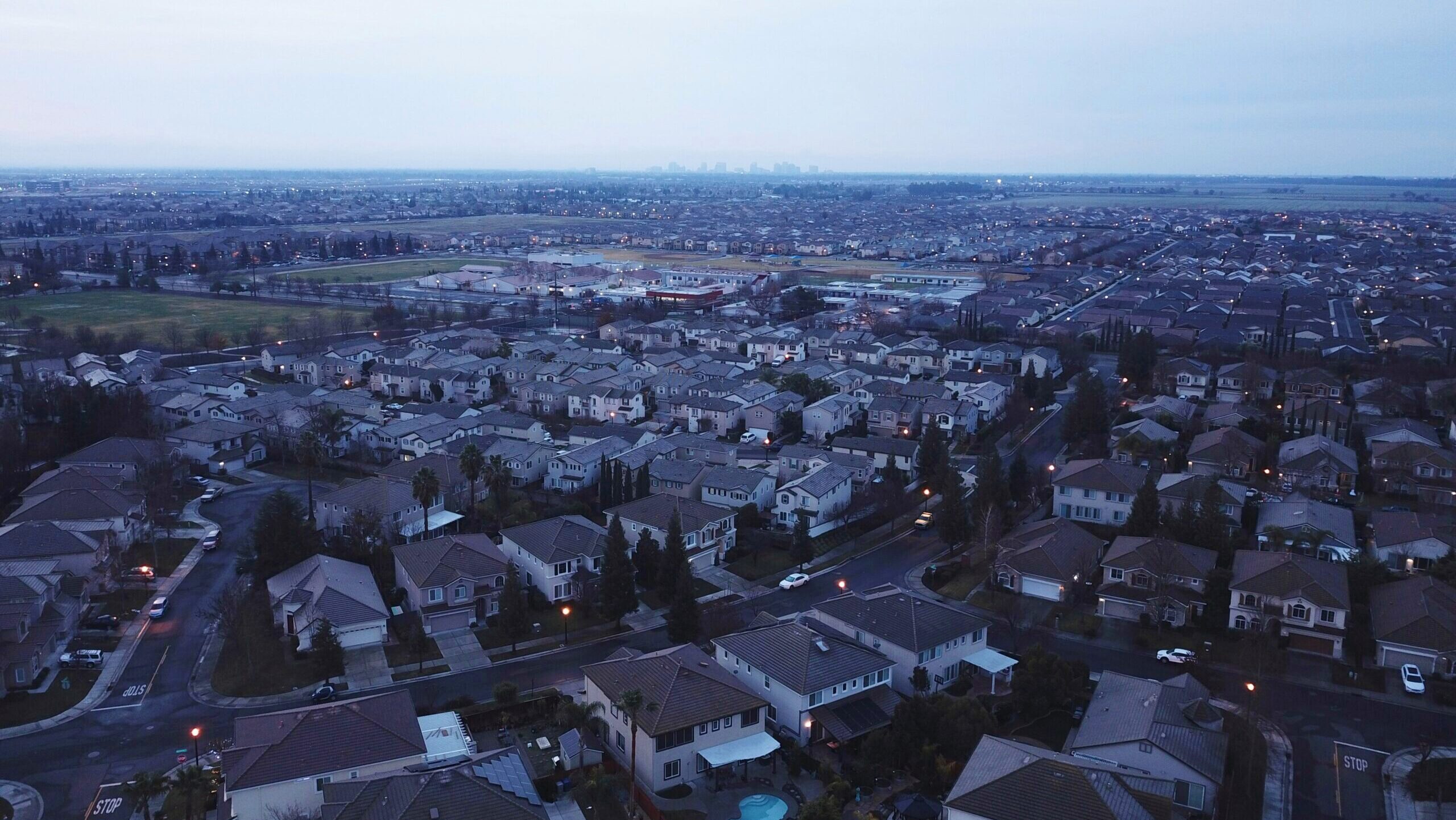 An area containing residential homes in Sacramento, California is shown looking towards the city's downtown.