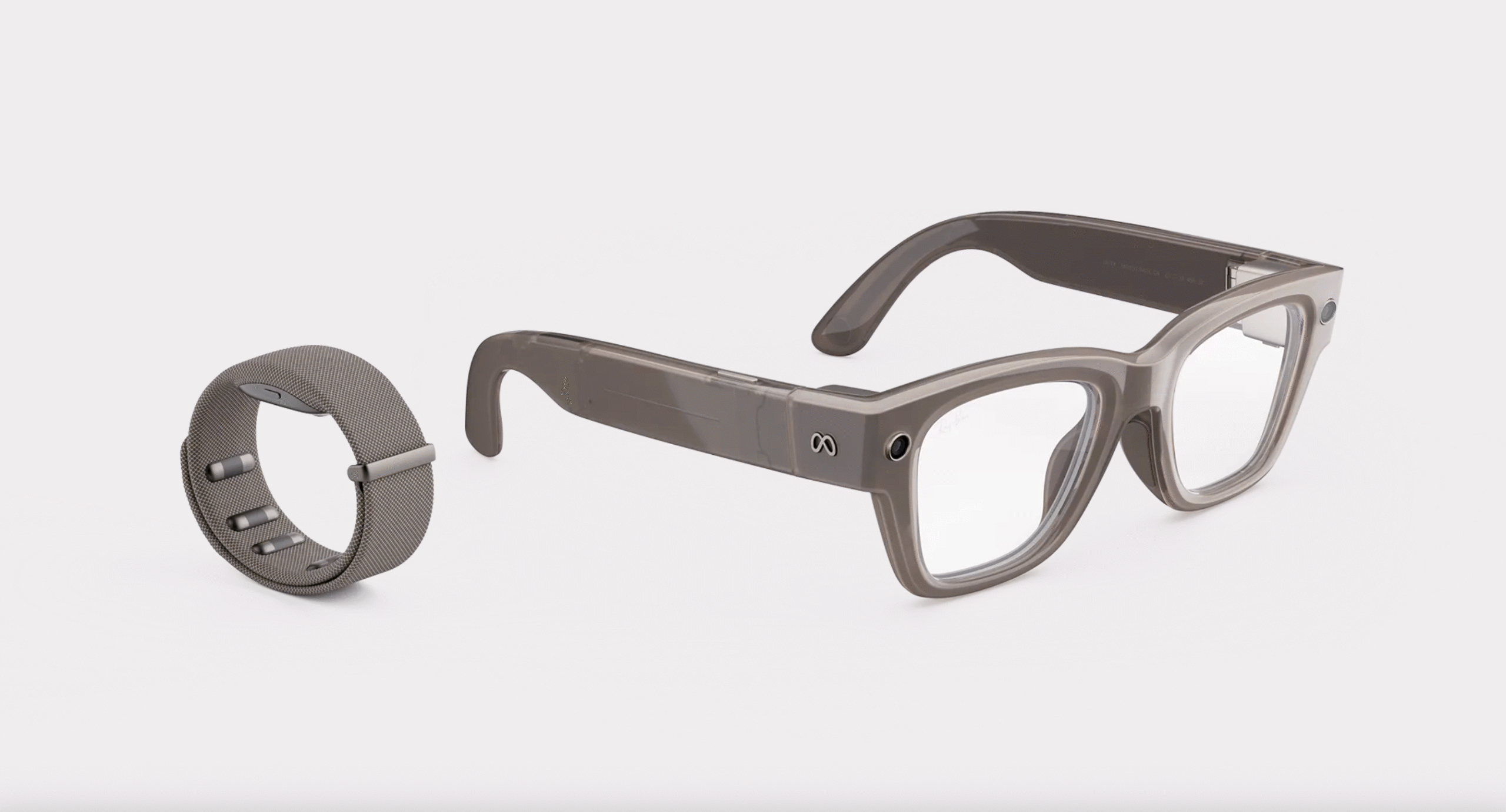 A Meta Neural Band is shown next to a pair of Meta Ray-Ban Display glasses.