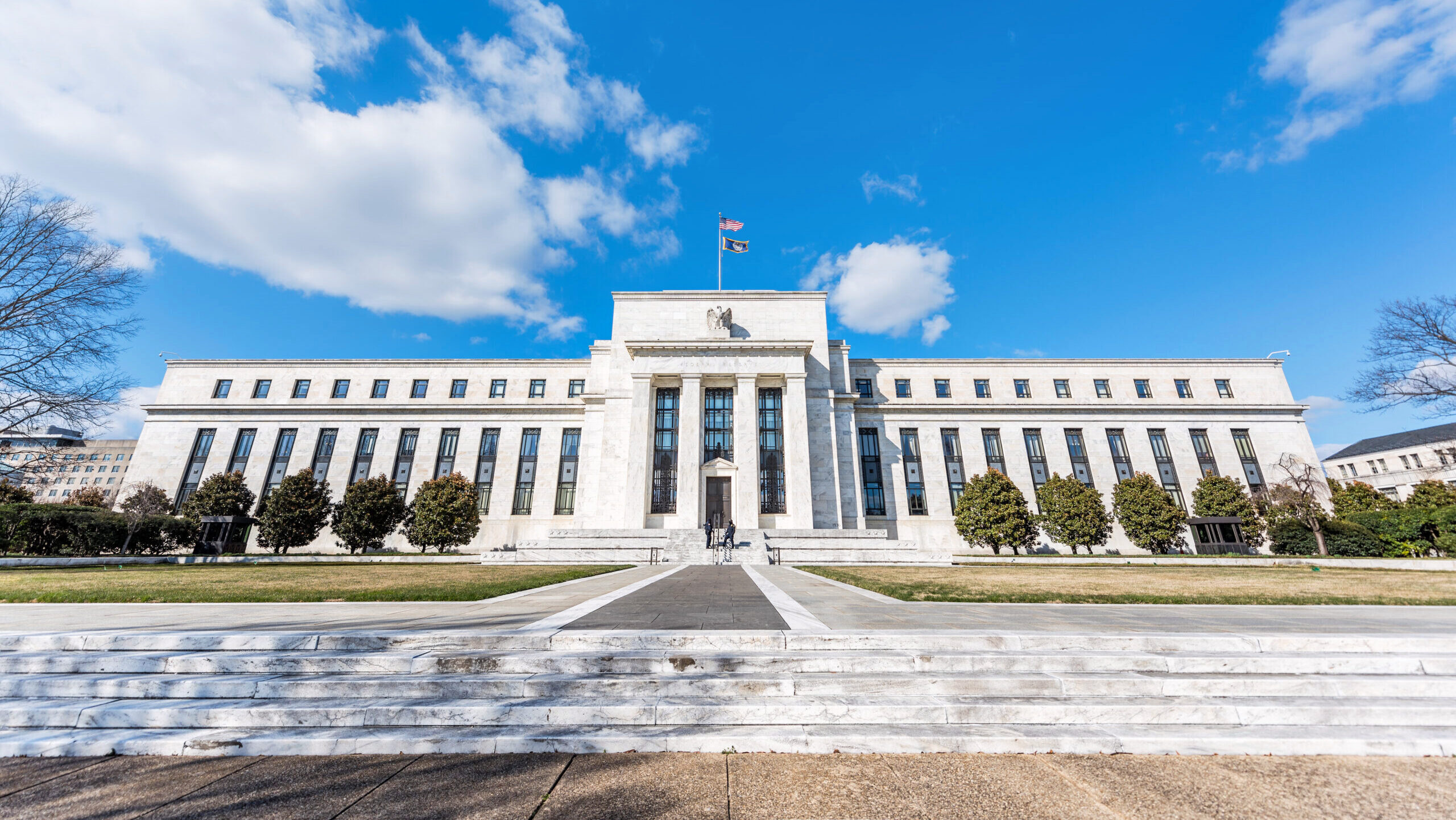 The Federal Reserve bank entrance in Washington DC is shown.