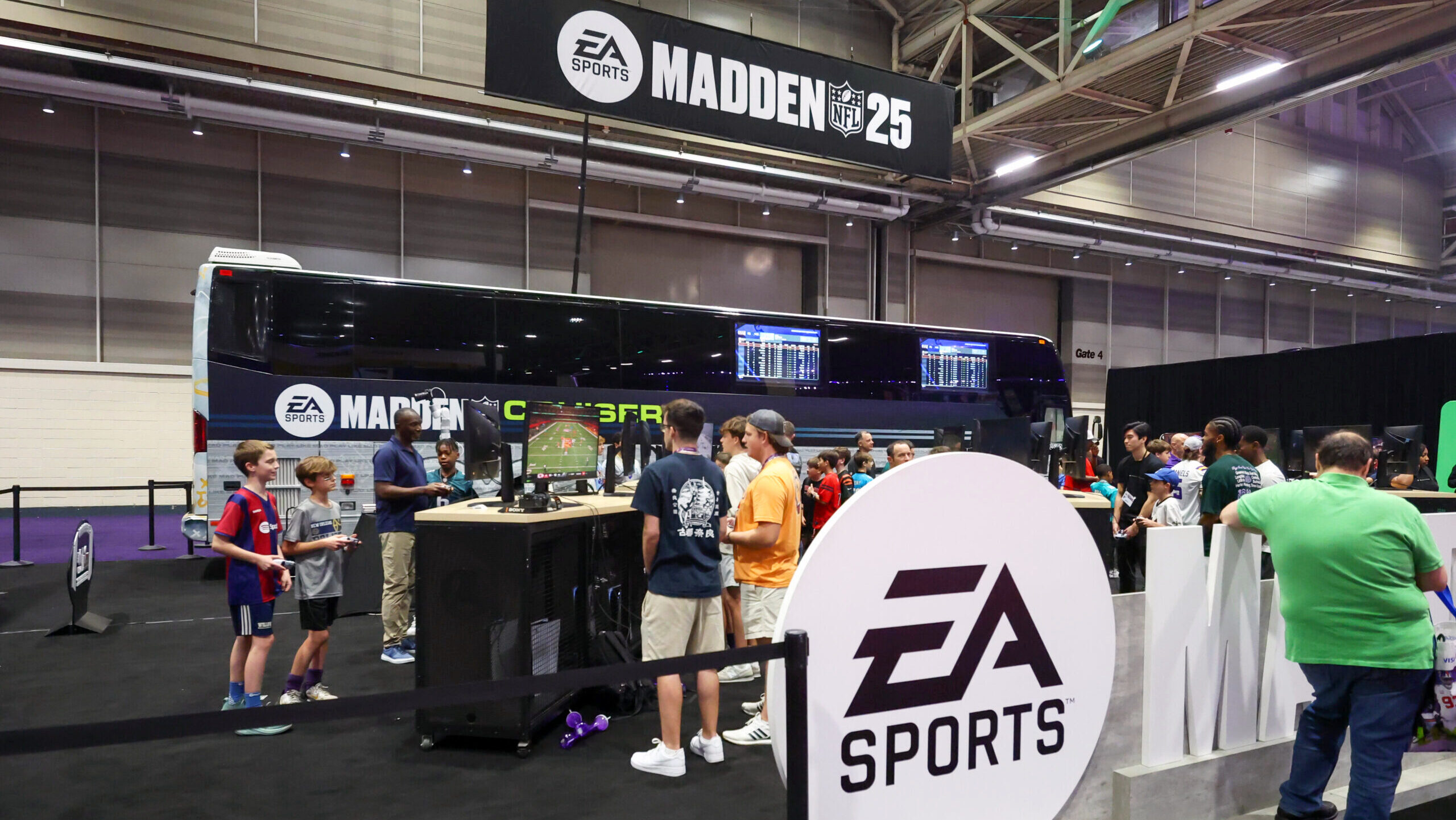 Photo of fans playing Madden 25 at an event.