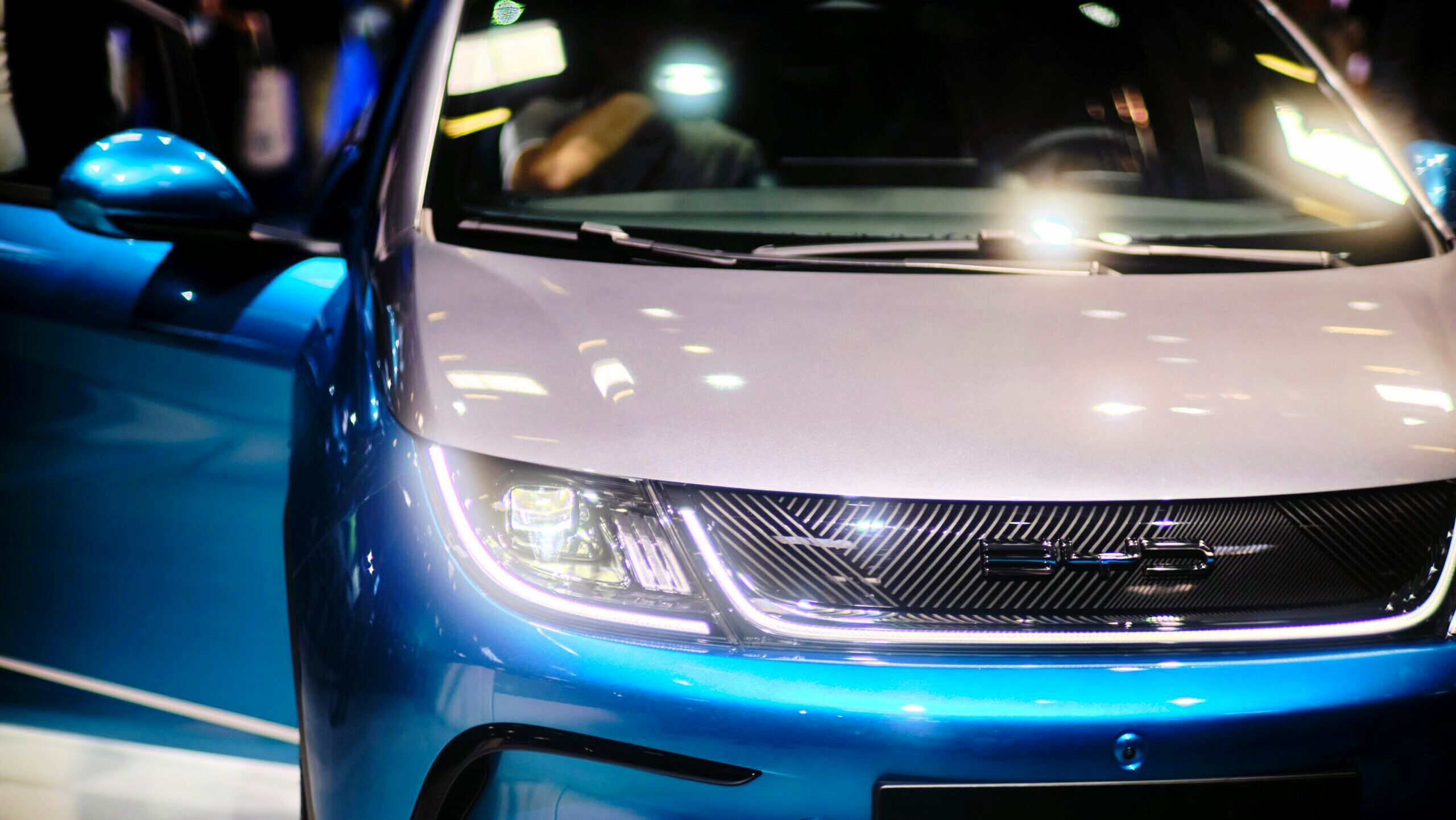 A BYD electric vehicle is shown with its door open.