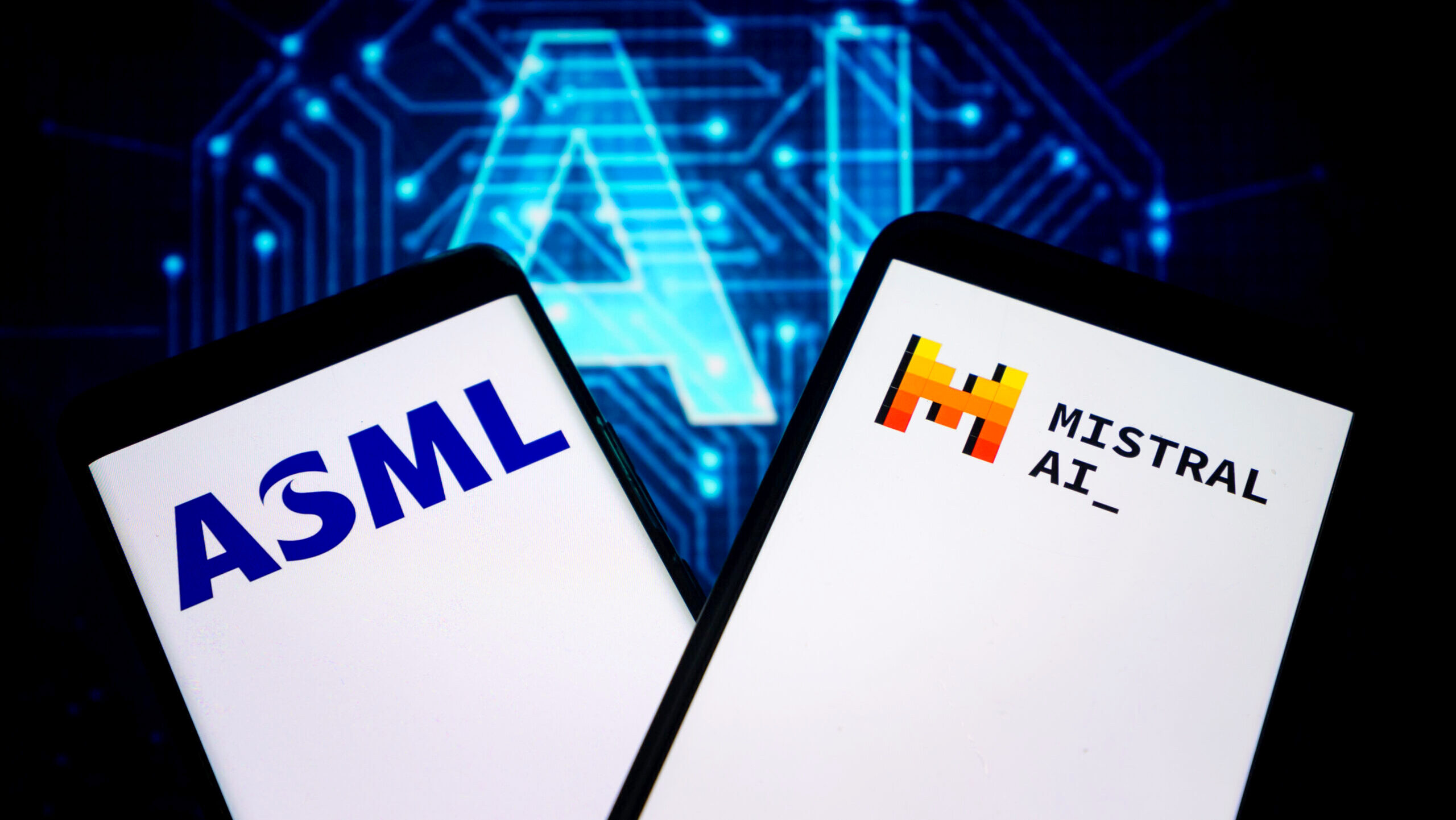 Two mobile phone screens show the logos of ASML and Mistral AI.