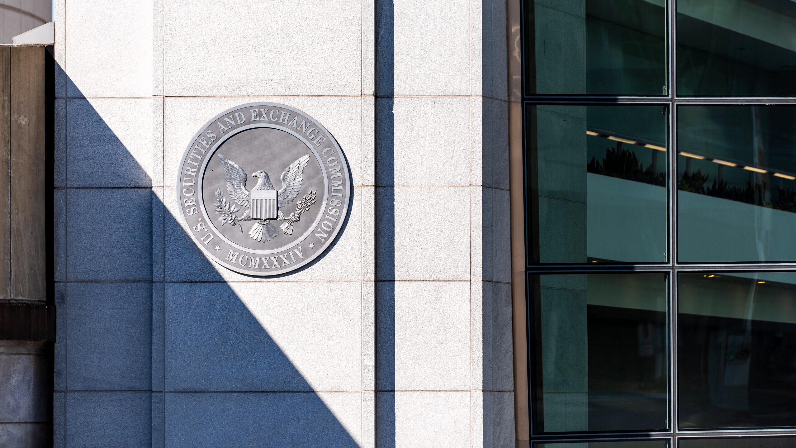 The entrance to the United States Securities and Exchange Commission building in Washington, DC is shown with the commission's logo visibly displayed.
