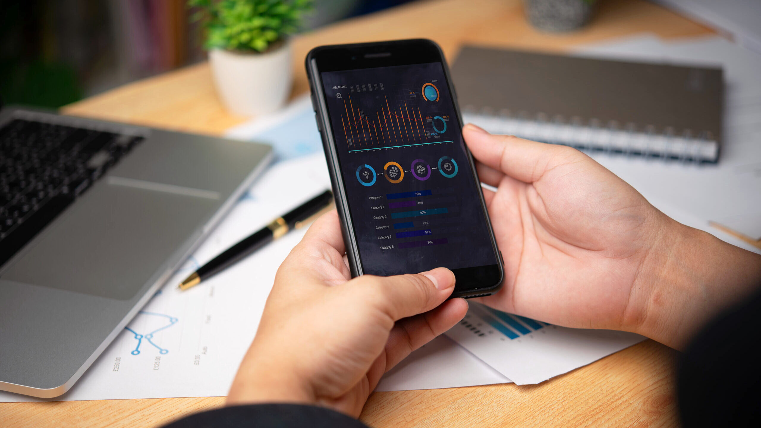 Photo of a man checking stocks on a smartphone.