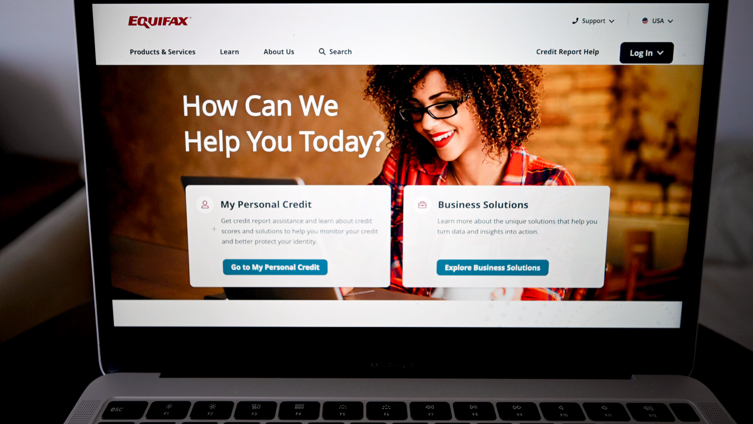 An open laptop shows a view of the Equifax website.