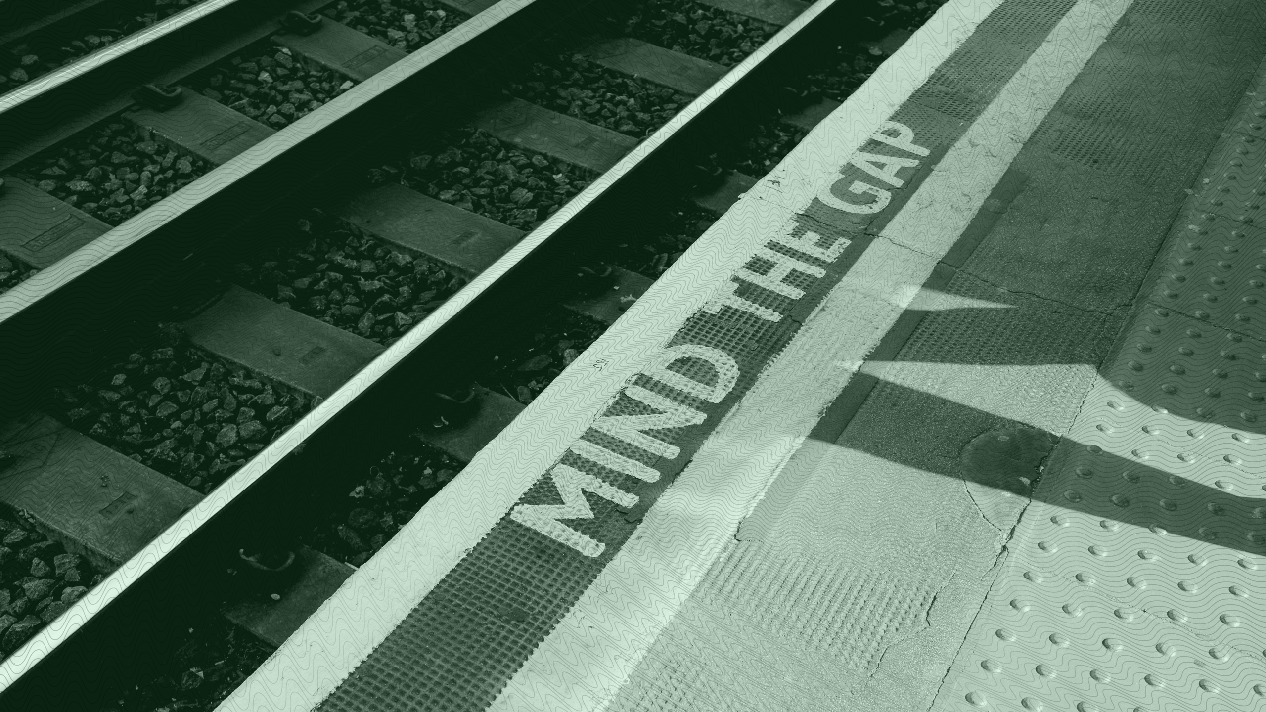Photo of train tracks behind a "Mind the Gap" warning