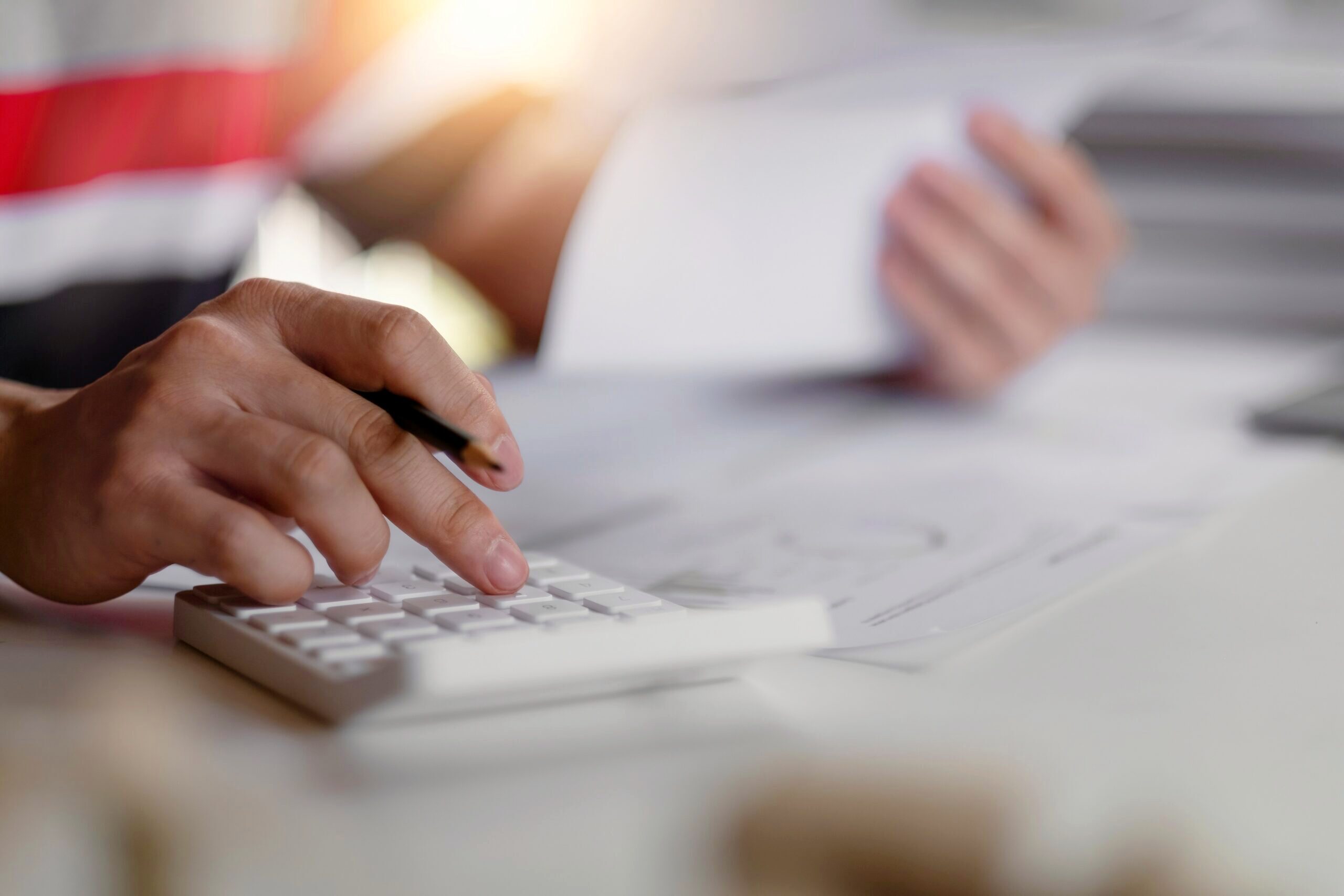 Photo of someone working on a calculator.