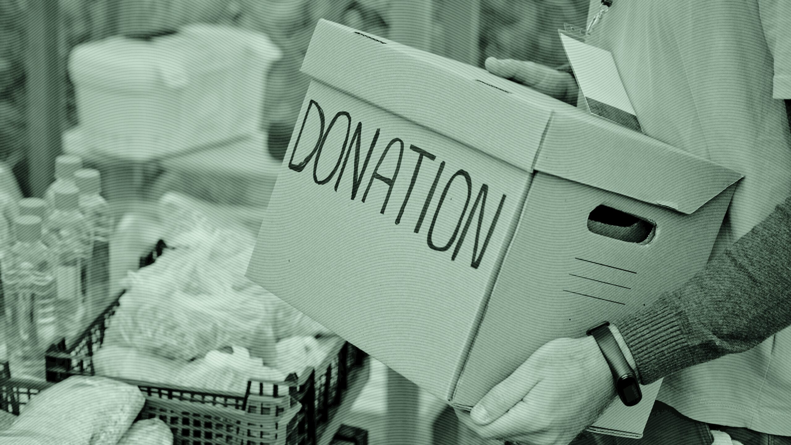 A person holding a box of donations.