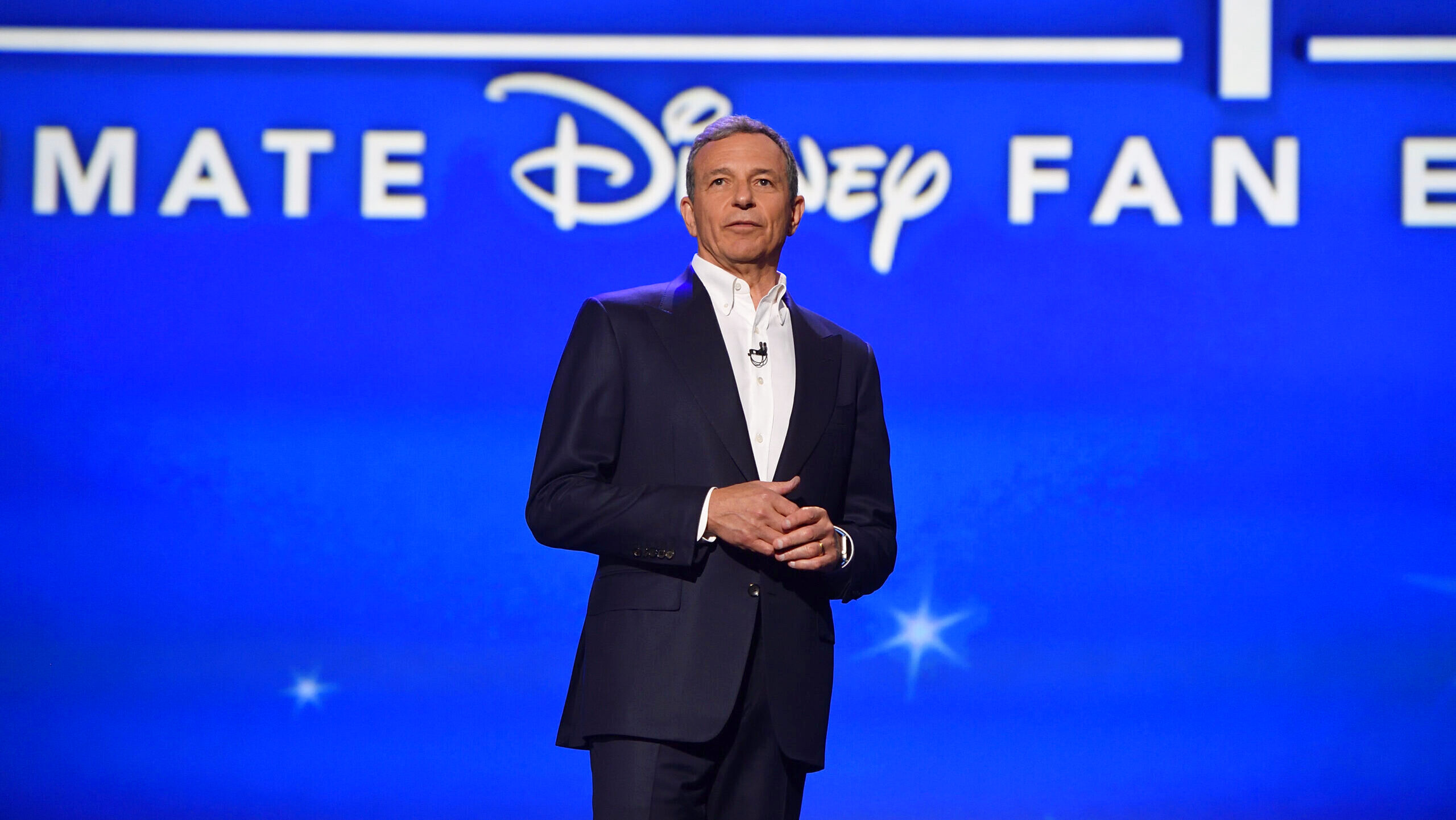 Disney CEO Bob Iger is shown on stage in Anaheim in front of the company's signature logo during the Disney Legends award ceremony.