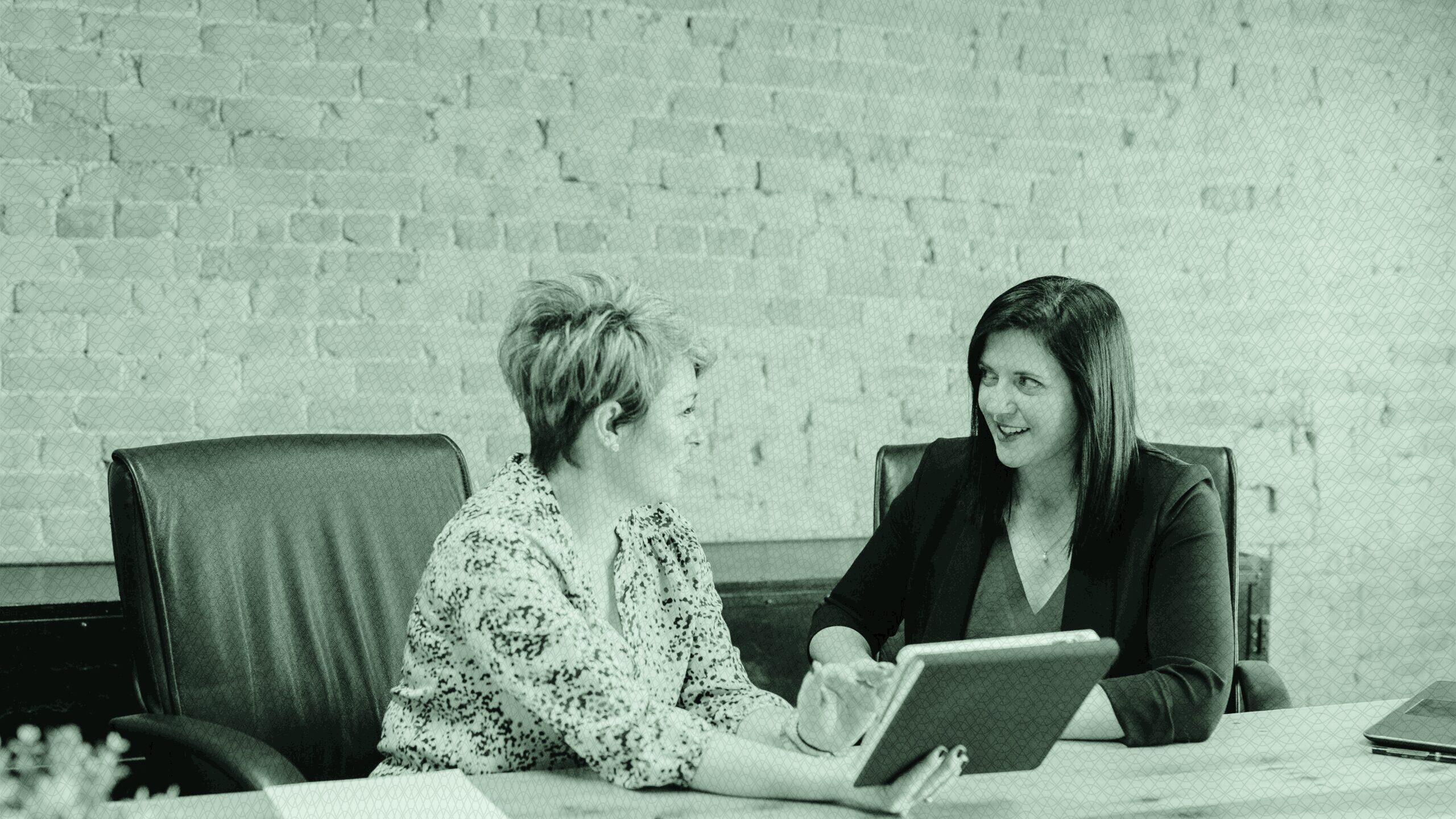 A woman advising another woman.