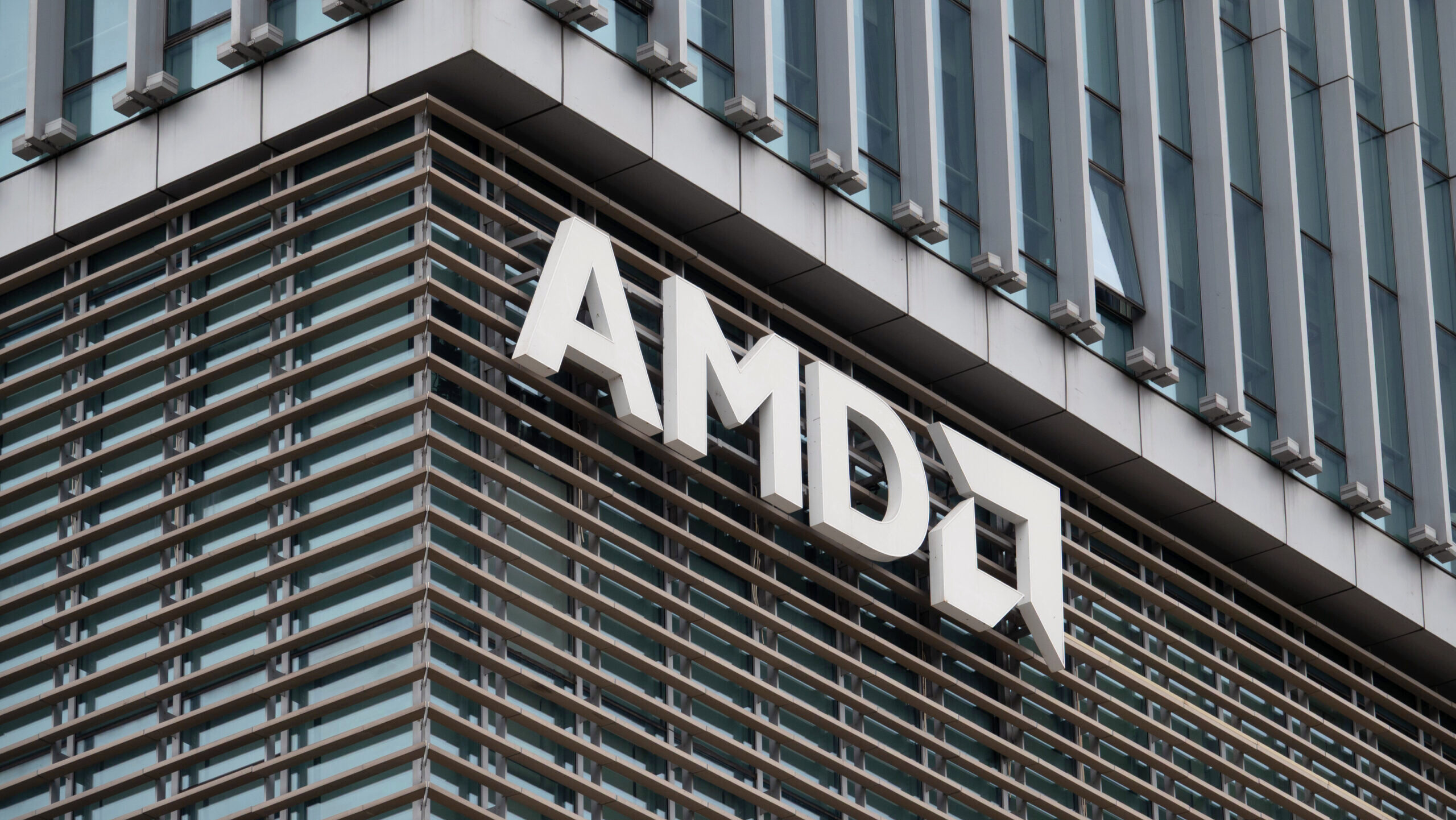 The AMD logo appears on the side of a corporate R&D facility.