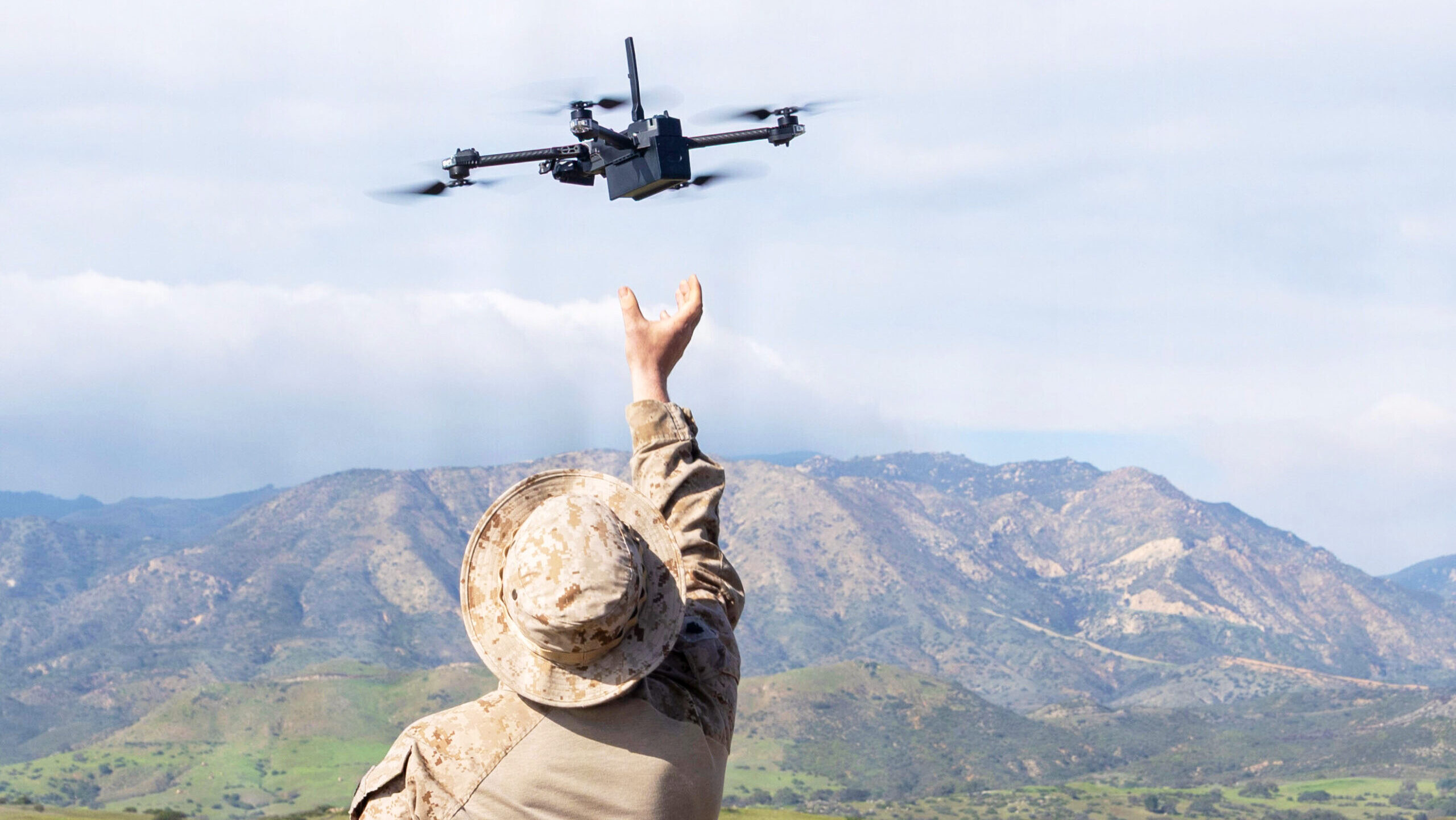 Photo of a US marine catching a small drone.