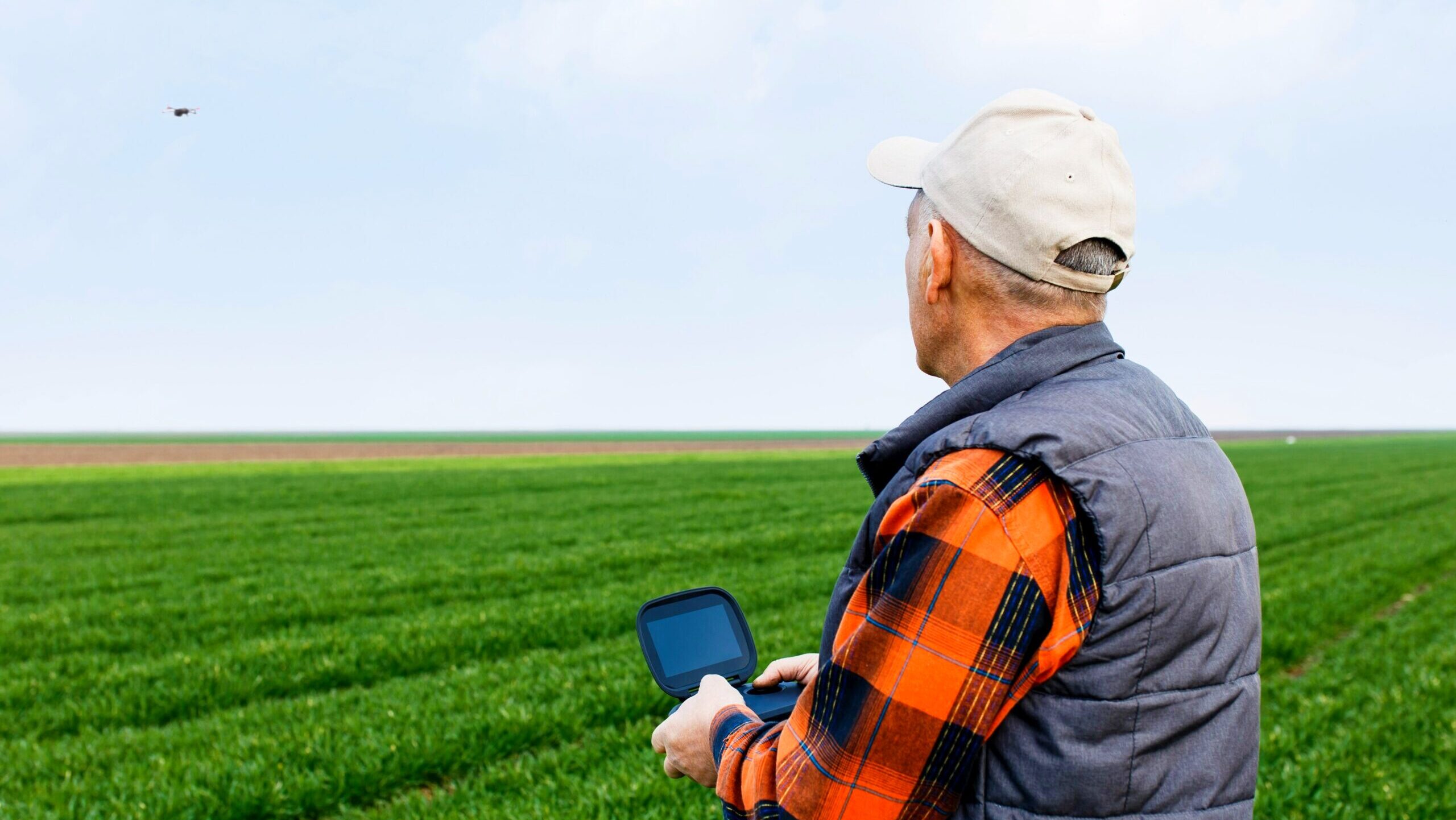Photo of a farmer using a drone.