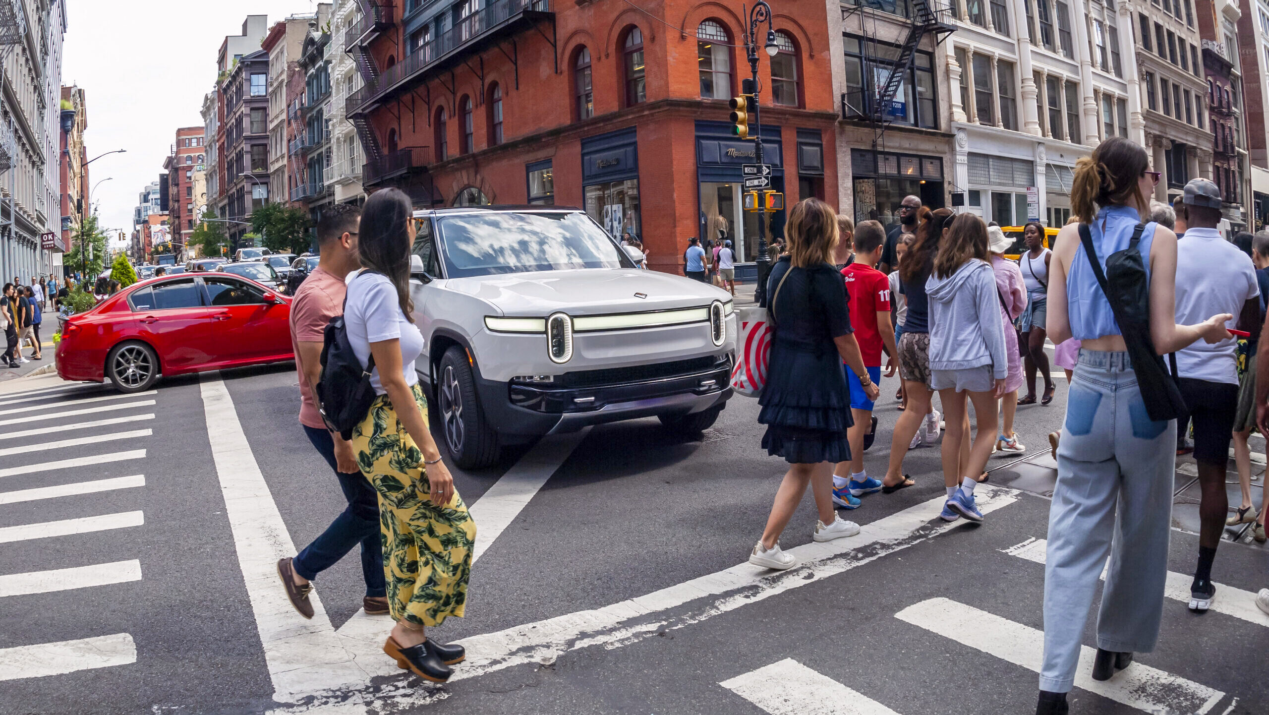 A Rivian electric SUV is shown stuck in traffic in Soho in New York City.