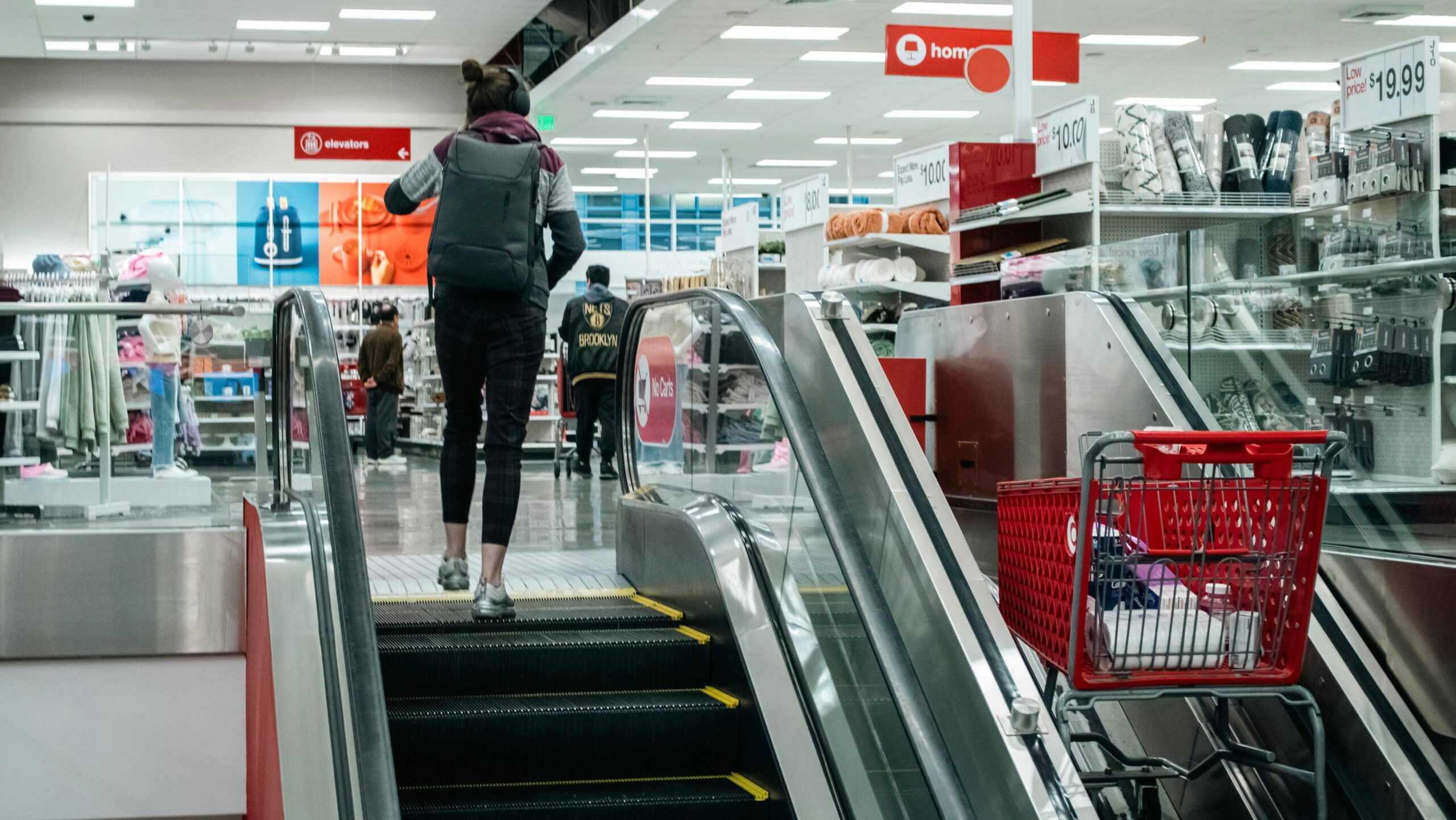 Photo of woman ascending escalator in a Target store.